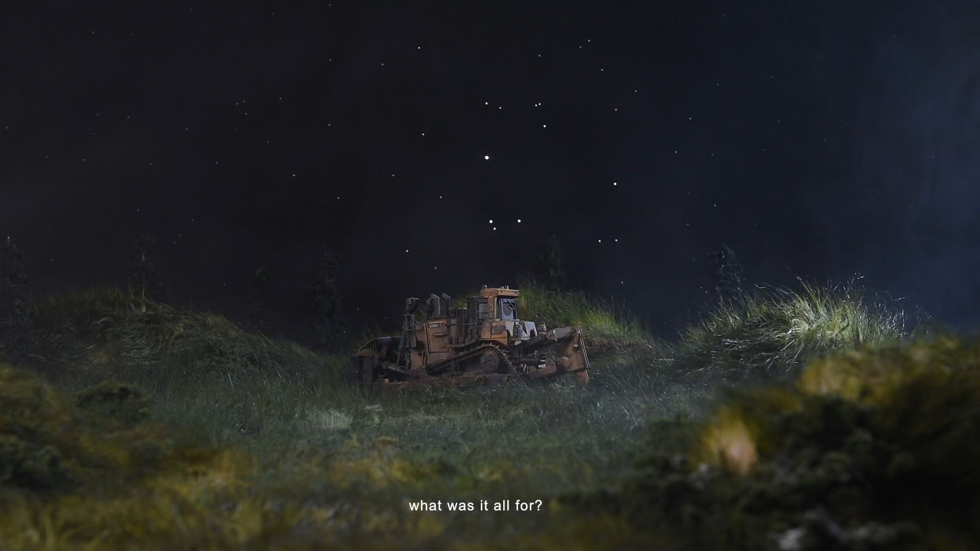 A bulldozer in a grassy field at night under a starry sky, with the text 'what was it all for?' at the bottom.