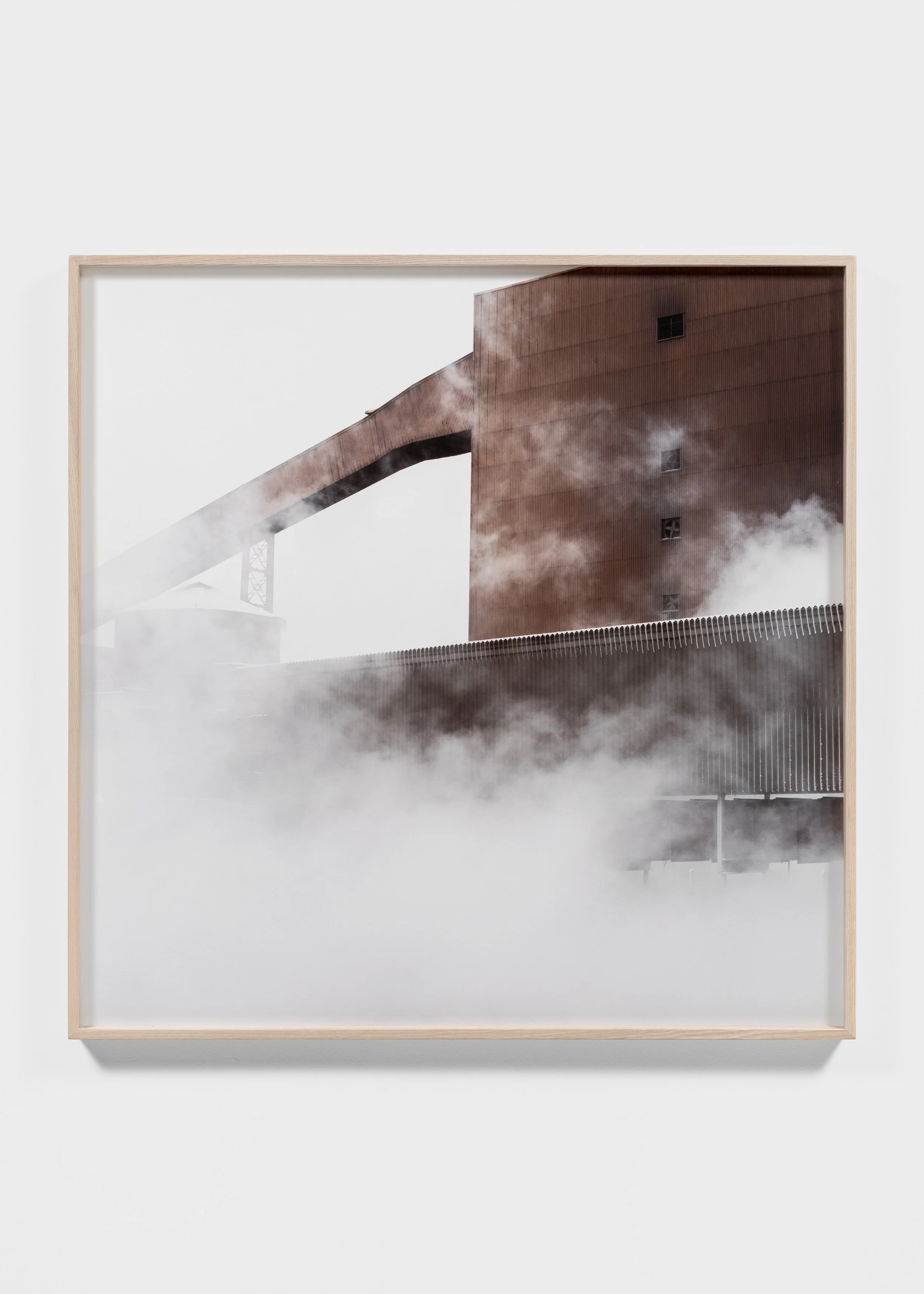 Industrial building with smoke and fog in a wooden frame.