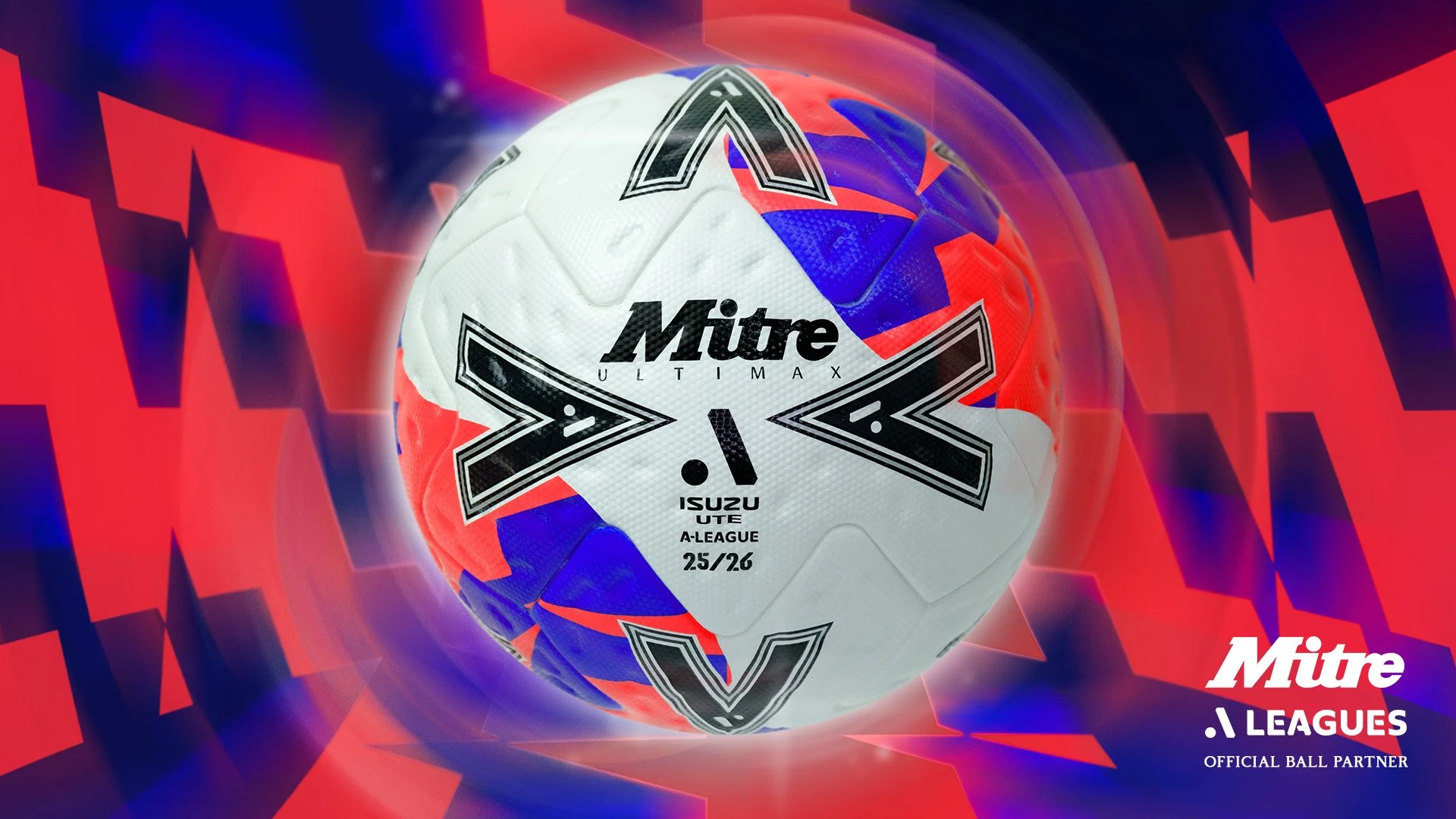 A white Mitre football with red, blue, and black geometric patterns and branding, set against a digital, abstract red and blue background with the Mitre V-League logo in the lower right corner.