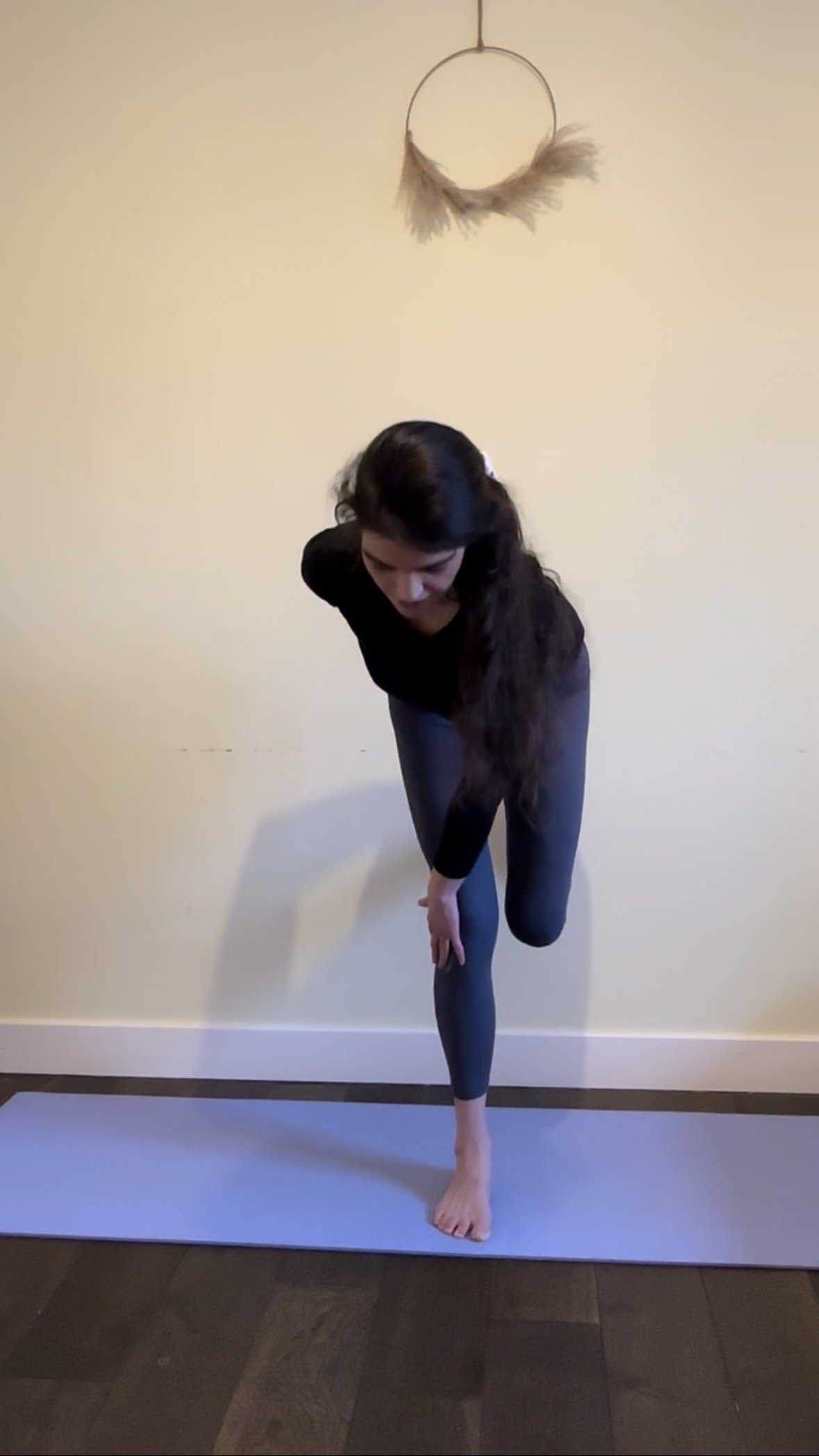 postnatal mother practicing closed chain hip hinge