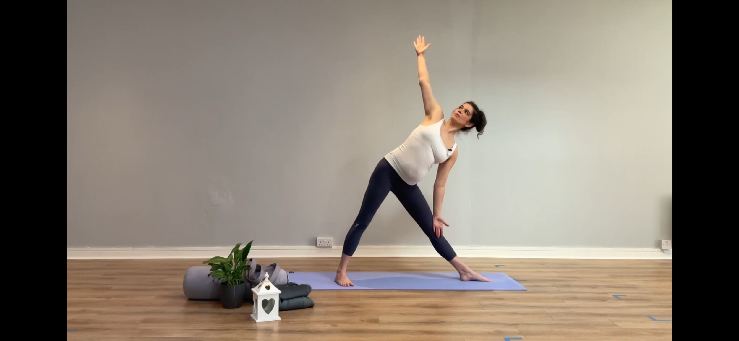A woman practicing pregnancy yoga in 2nd trimester