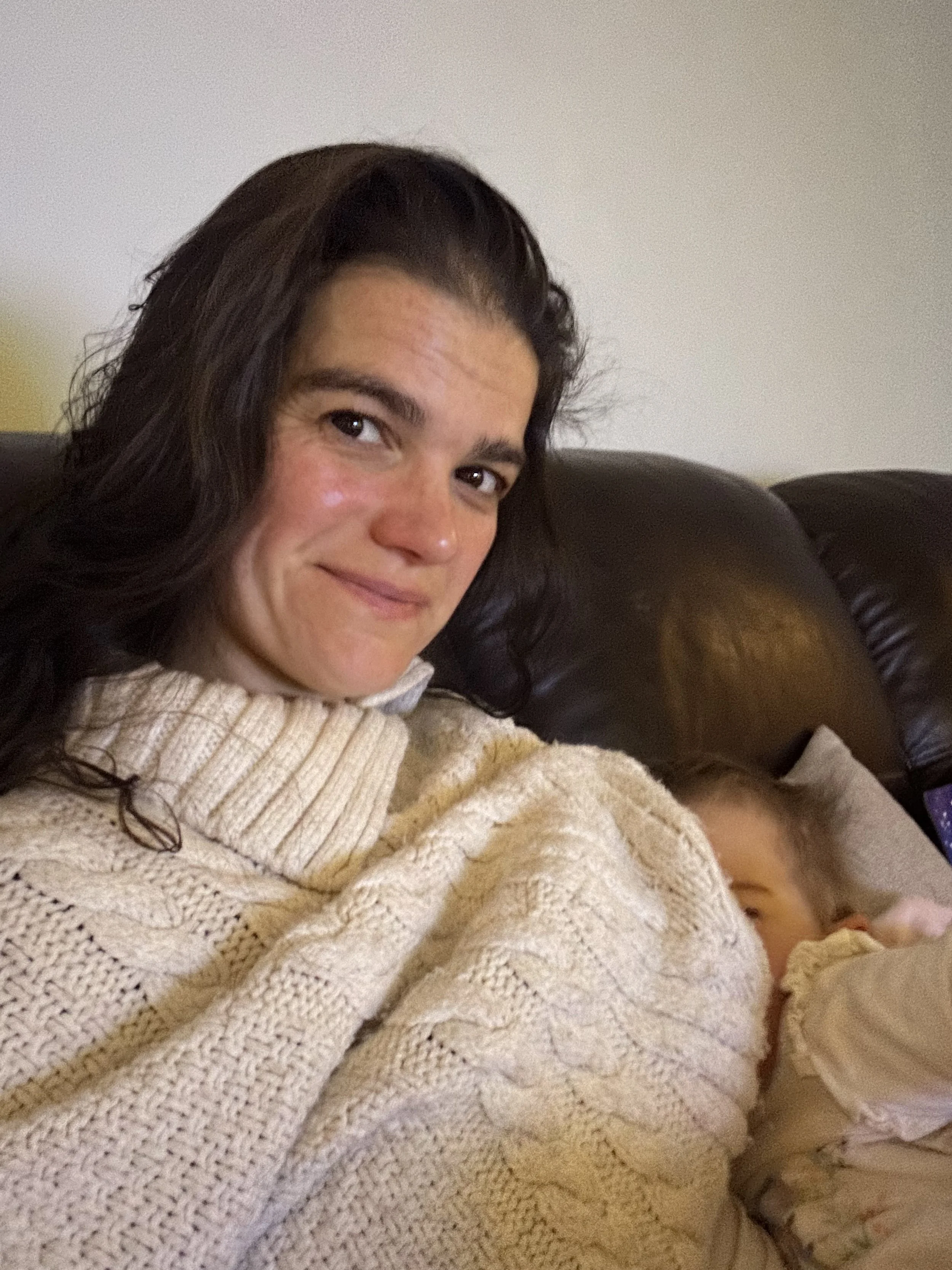 Postnatal mother breastfeeding her two year old child