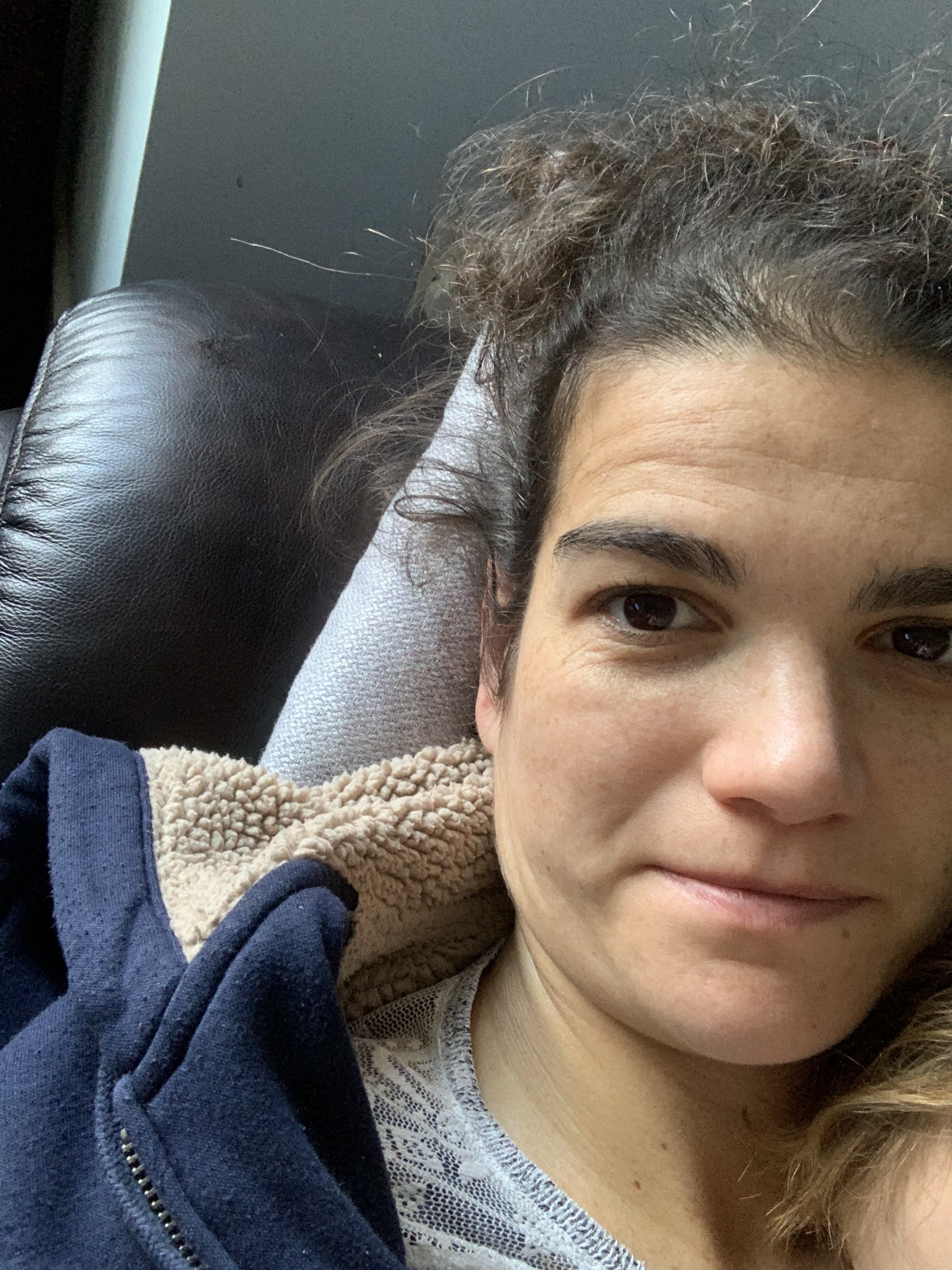 woman in early pregnancy lying on sofa with first child