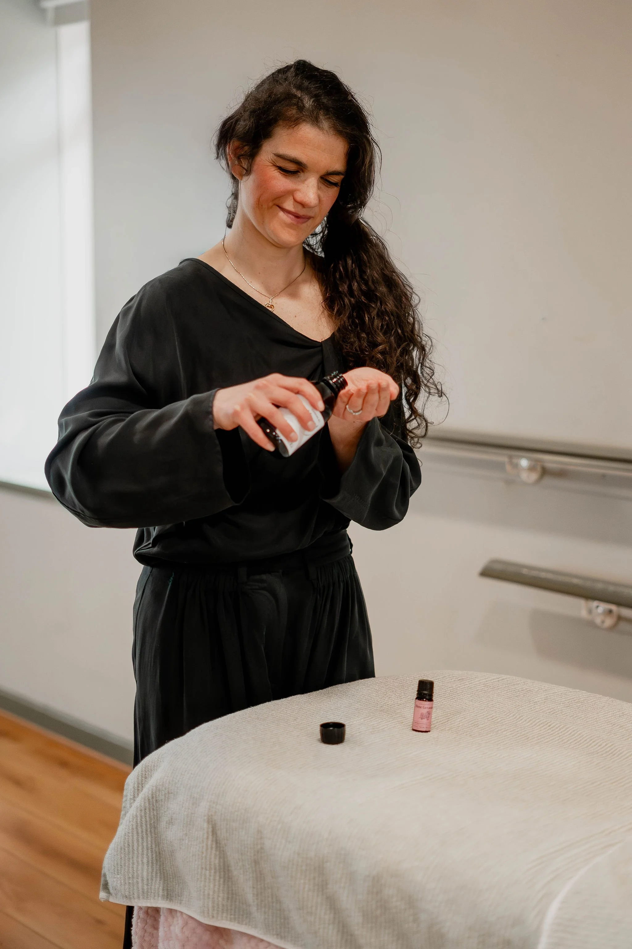 mother sharing post natal massage with essential oils
