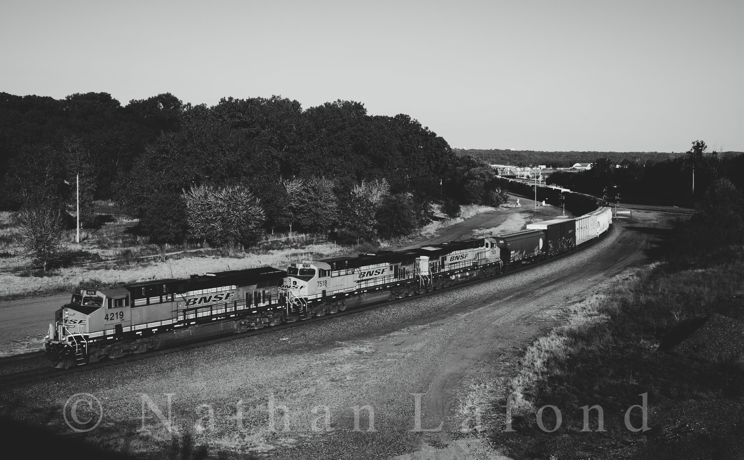 BNSF train NSI-NTW rounds the curve at West Division Street, en-route to Northtown Yard in Minneapolis with a trio BNSF GE's for power. - St. Paul, Minnesota.
