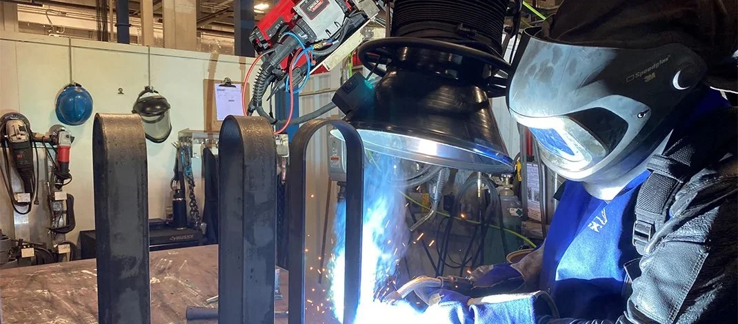Photo of person welding, symbolizing manufacturing growth in Oswego County