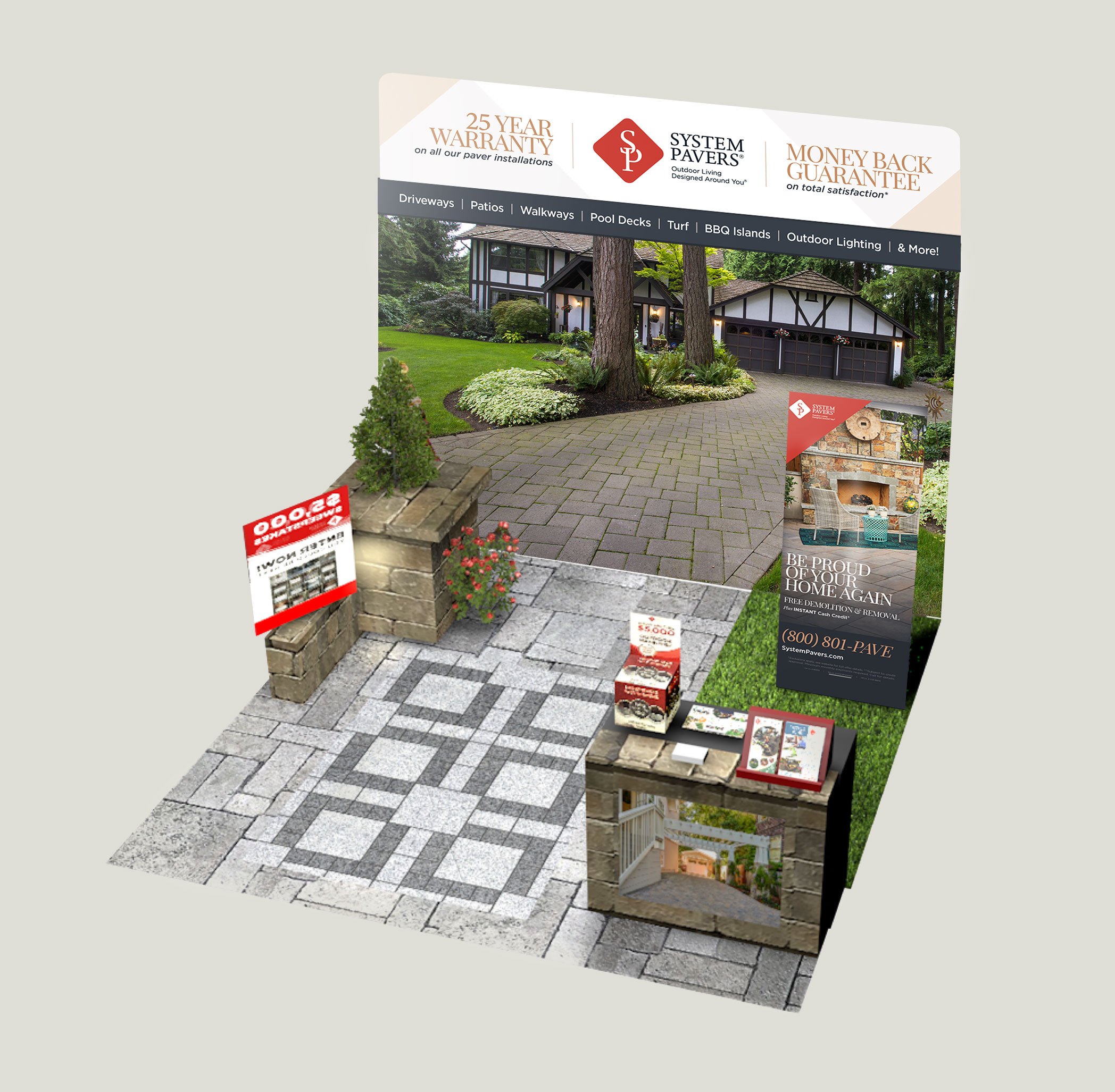 A promotional outdoor display for System Pavers showing a house with a landscaped yard, driveway, and garden, along with brochures and signs advertising warranties and guarantees.