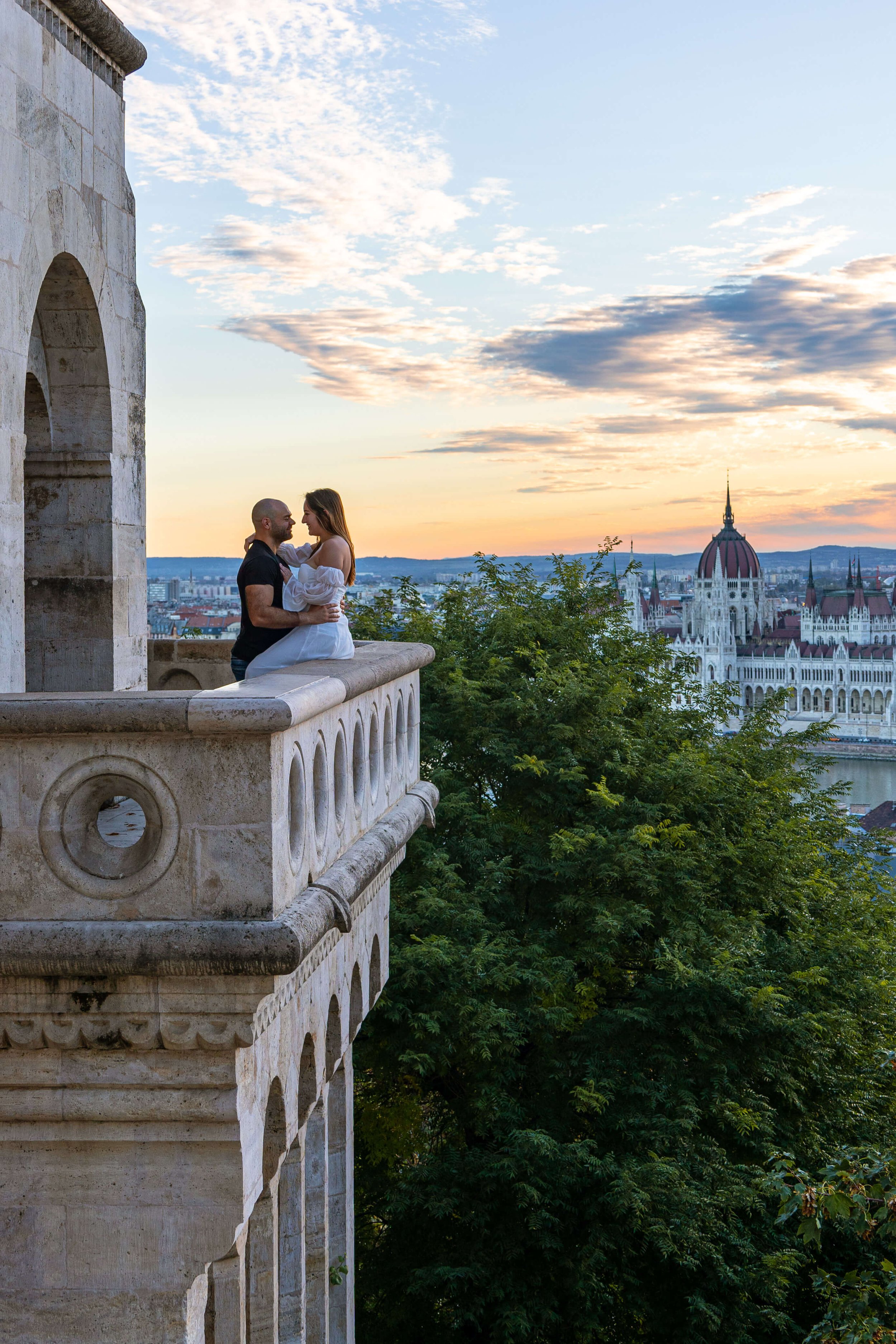 couple in love at fishermans basion with hungarian parliament in background budapest hungary.jpg