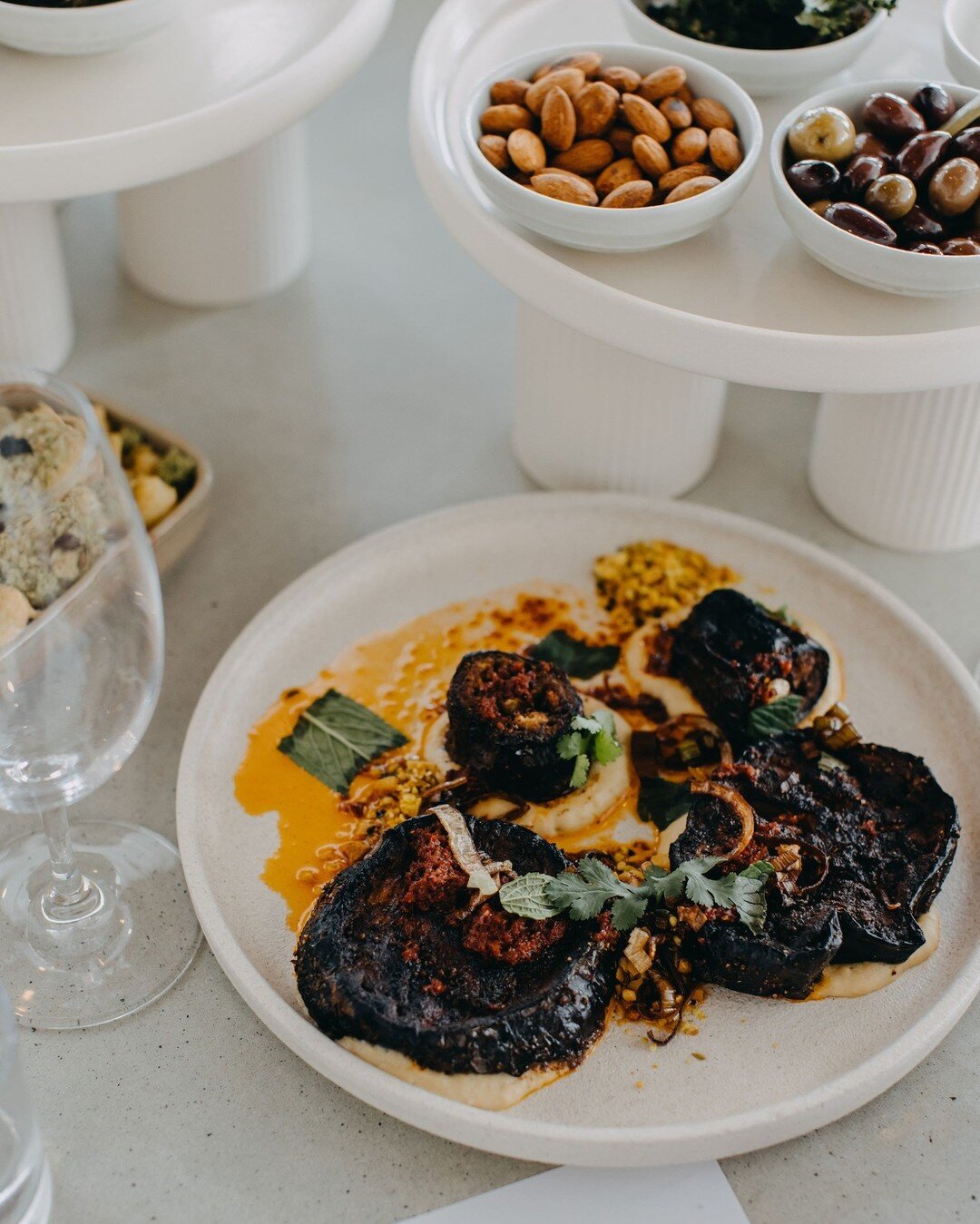 Our newly developed lunch offering has a variety of dishes to suit all nutritional needs like gluten free, dairy free, and vegan options like this Mediterranean style roast eggplant with hummus, dukkah, and crispy leek. #perthvegan