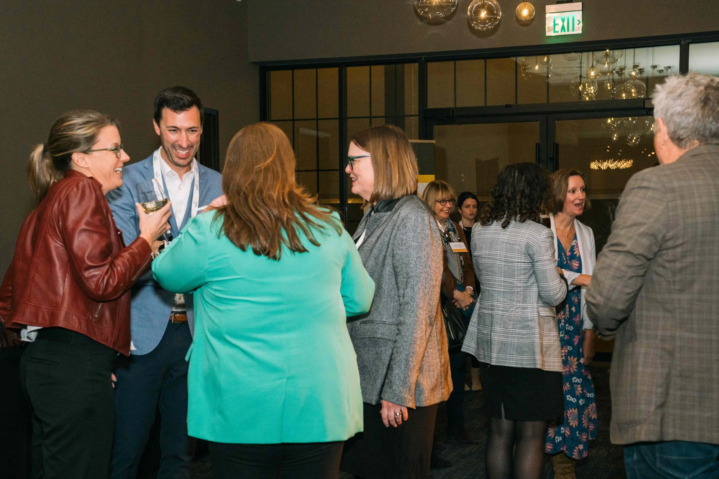 4 members laughing, drinking, and connecting with one another