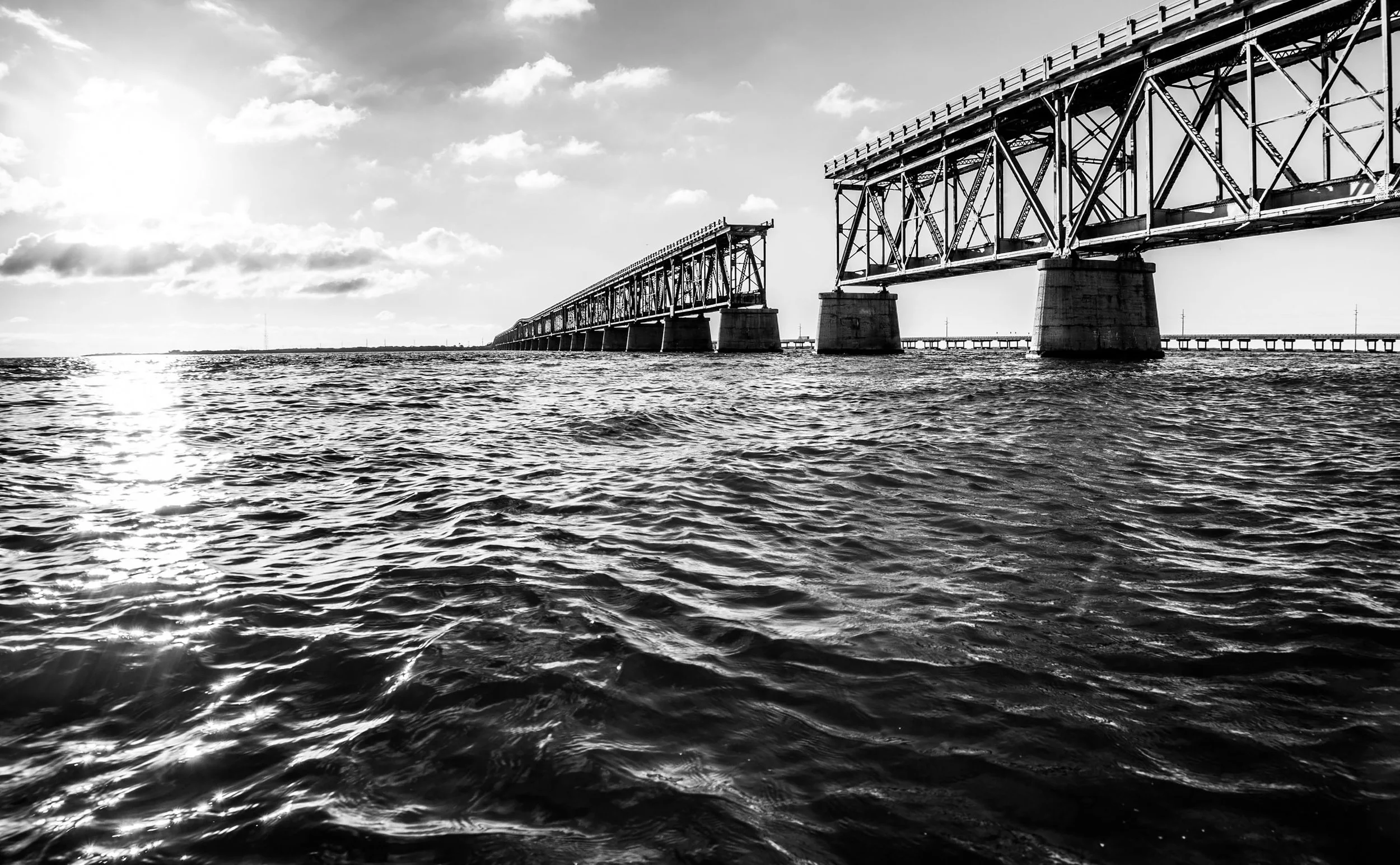 Coastal Vibes limited edition black-and-white fine art photograph by Jason Sponseller, featuring the Bahia Honda Bridge over ocean water in the Florida Keys with strong light, shadow, and coastal atmosphere