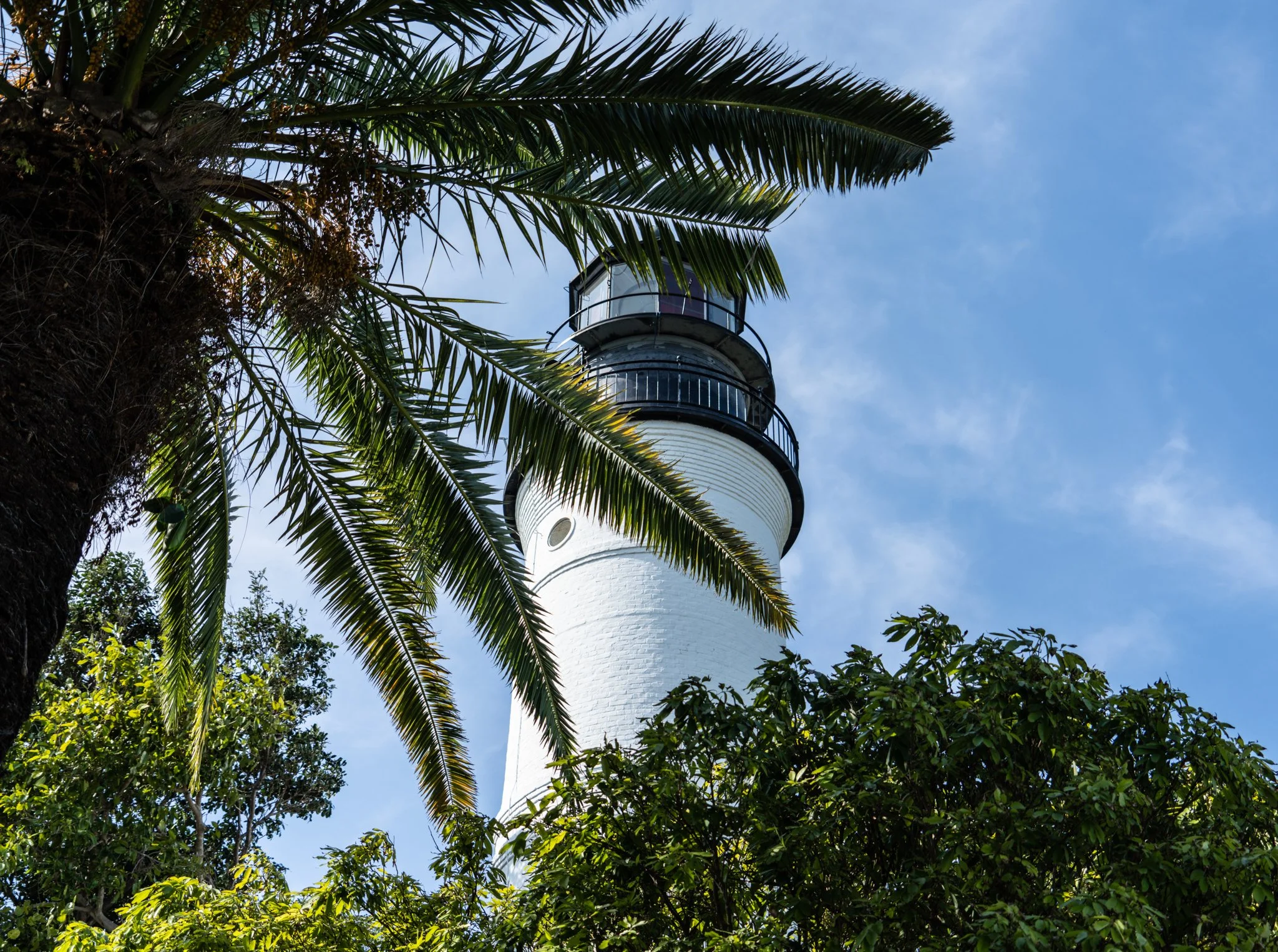 Coastal Vibes limited edition fine art photograph by Jason Sponseller, featuring Key West Lighthouse framed by palm trees under a blue Florida sky