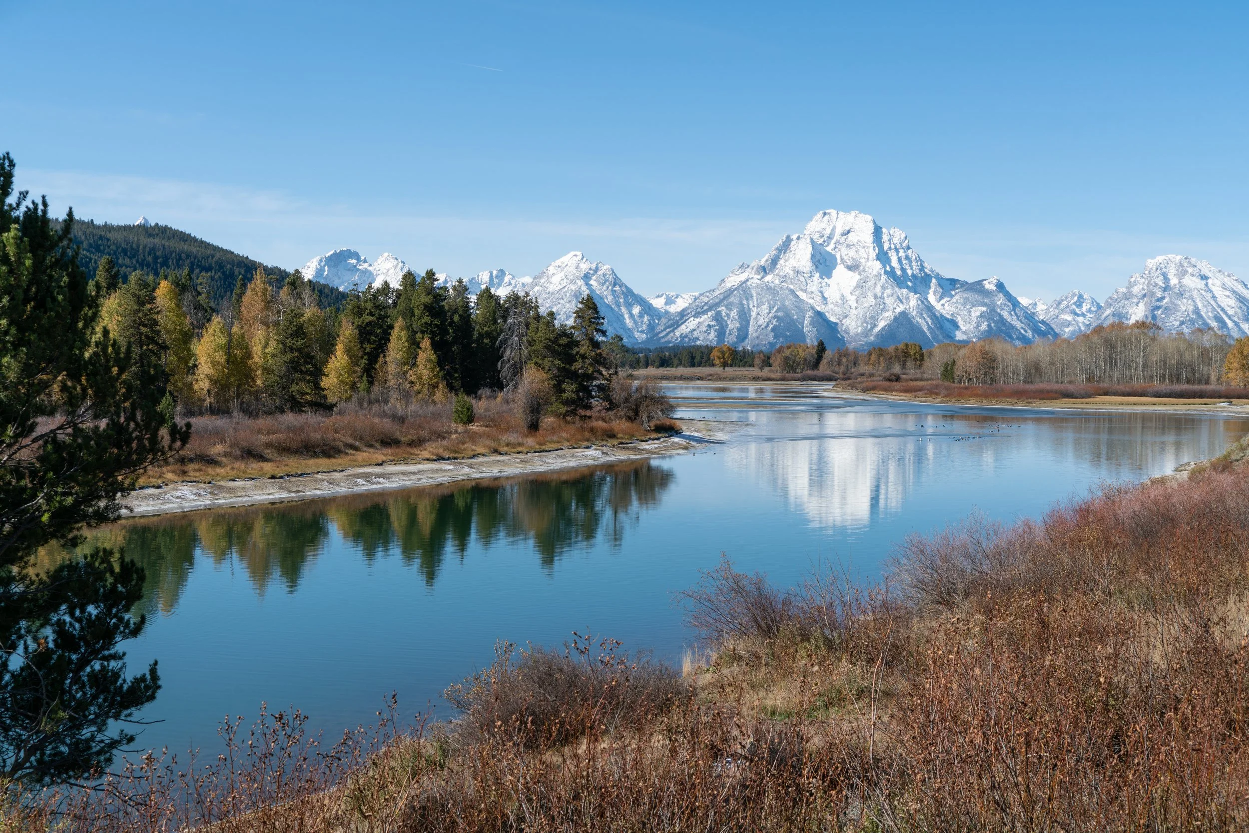 Dust and Distance: The Resonance of Time, limited edition fine art photograph by Jason Sponseller, featuring Grand Teton National Park with snow-covered mountains, river reflections, autumn trees, and quiet western landscape atmosphere