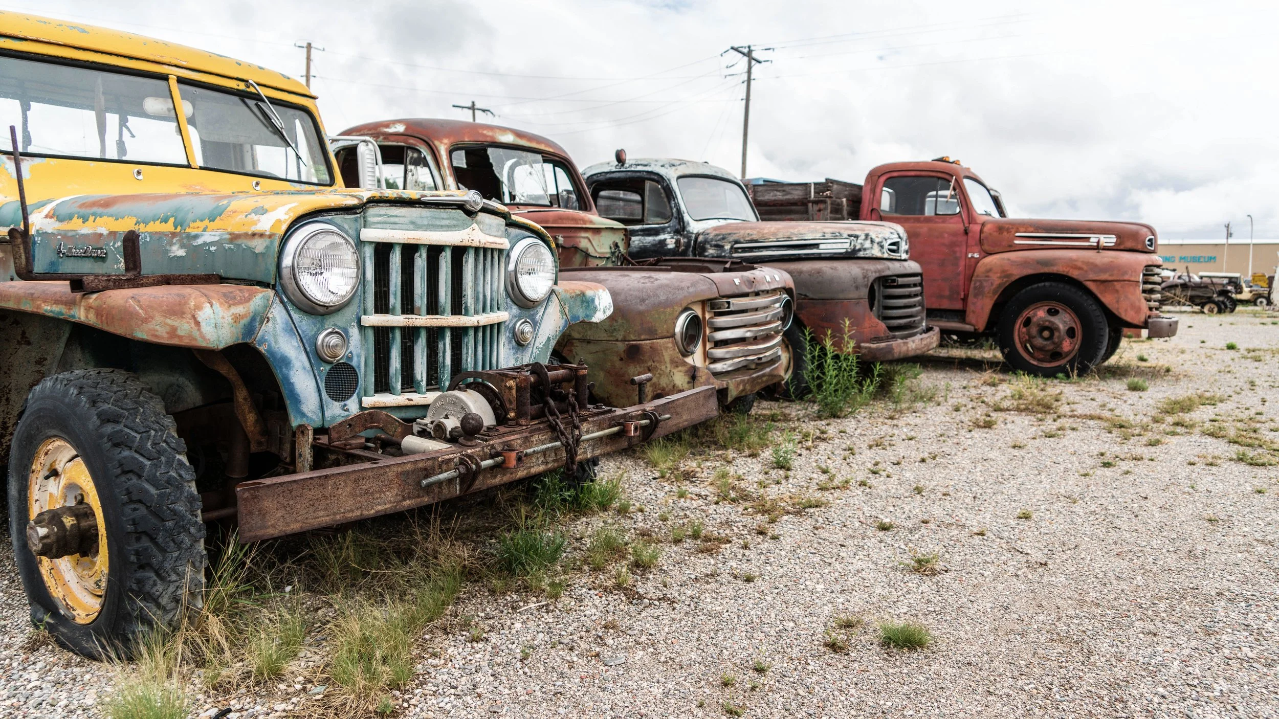 Limited edition fine art photograph by Jason Sponseller, featuring weathered vintage trucks in a junkyard along Route 66 in Moriarty, New Mexico, with rusted patina, roadside textures, and nostalgic Americana atmosphere