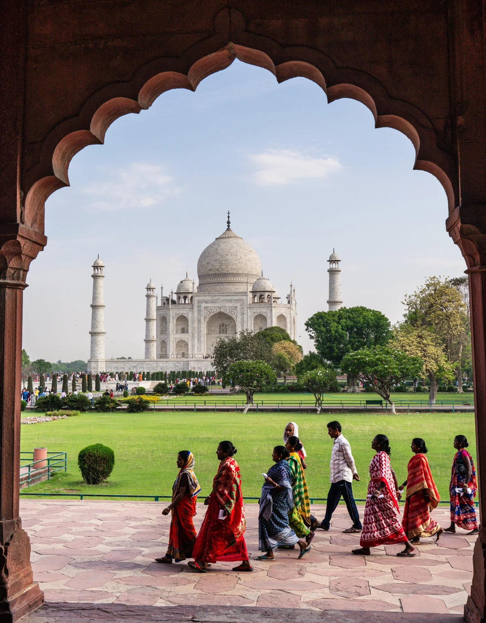 Limited edition fine art photograph by Jason Sponseller, featuring the Taj Mahal framed by an architectural arch with figures in vibrant color
