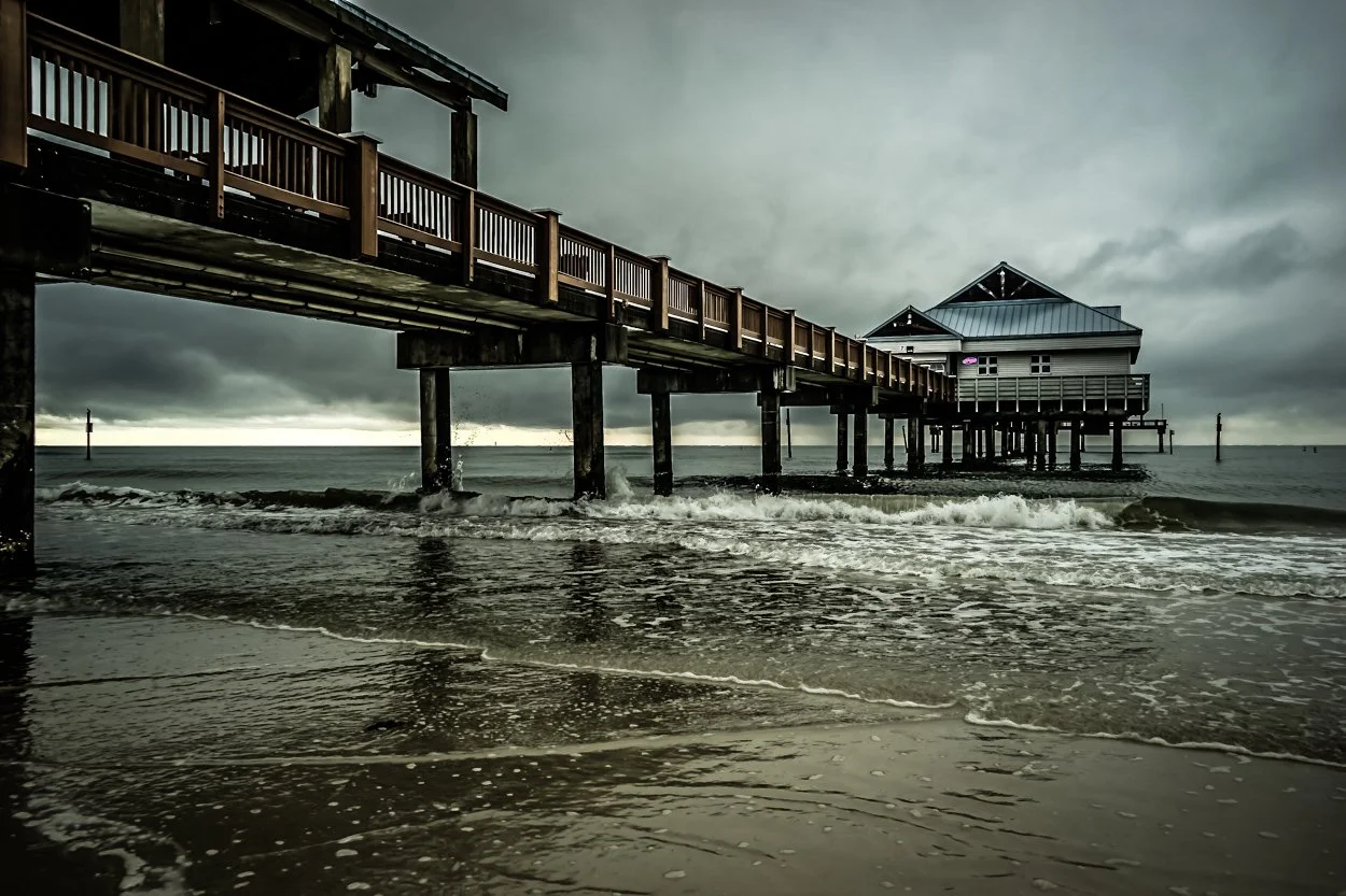 Coastal Vibes limited edition fine art photograph by Jason Sponseller, featuring Pier 60 in Clearwater Beach, Florida, beneath storm clouds with ocean waves, moody coastal light, and dramatic seaside atmosphere