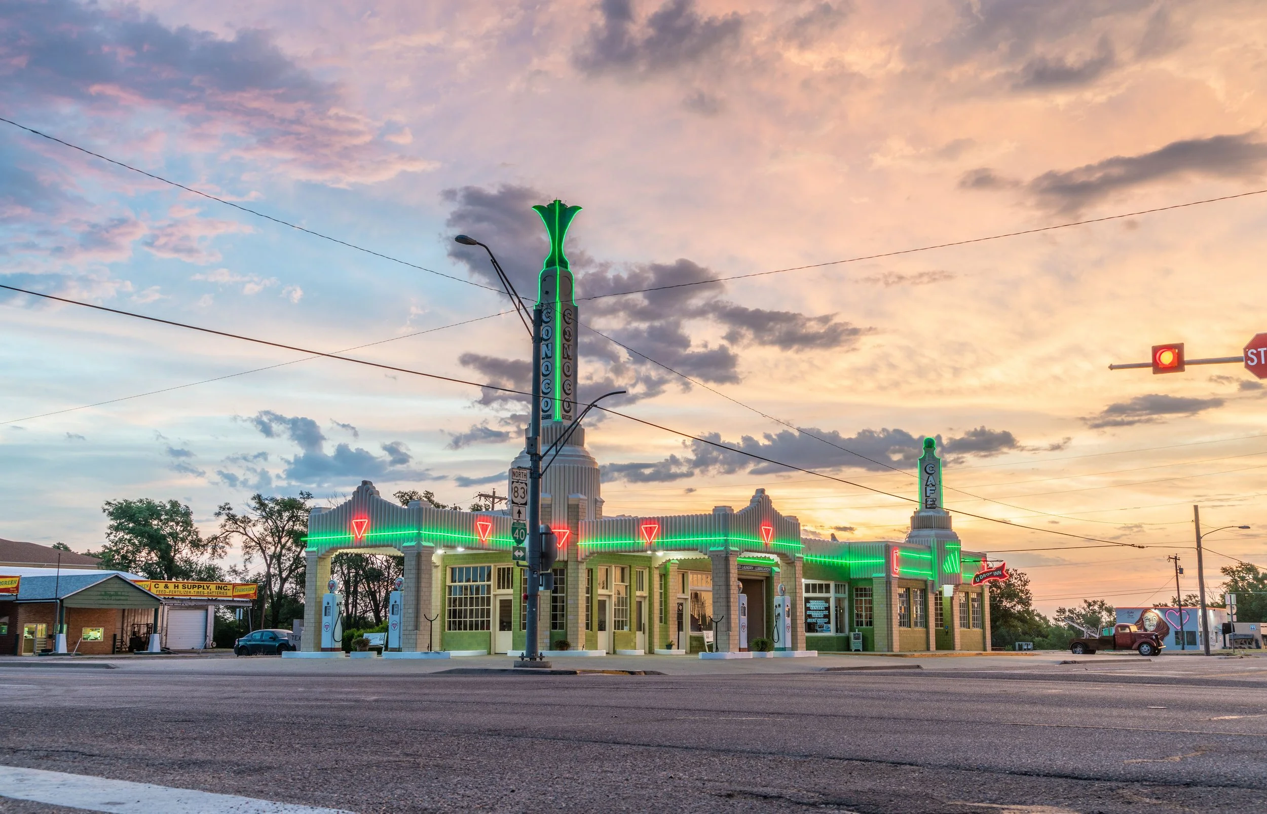 Limited edition fine art photograph by Jason Sponseller, featuring the neon-lit U-Drop Inn on Route 66 in Shamrock, Texas, a real-world inspiration for Ramone’s House of Body Art in Pixar’s Cars, beneath a pastel evening sky