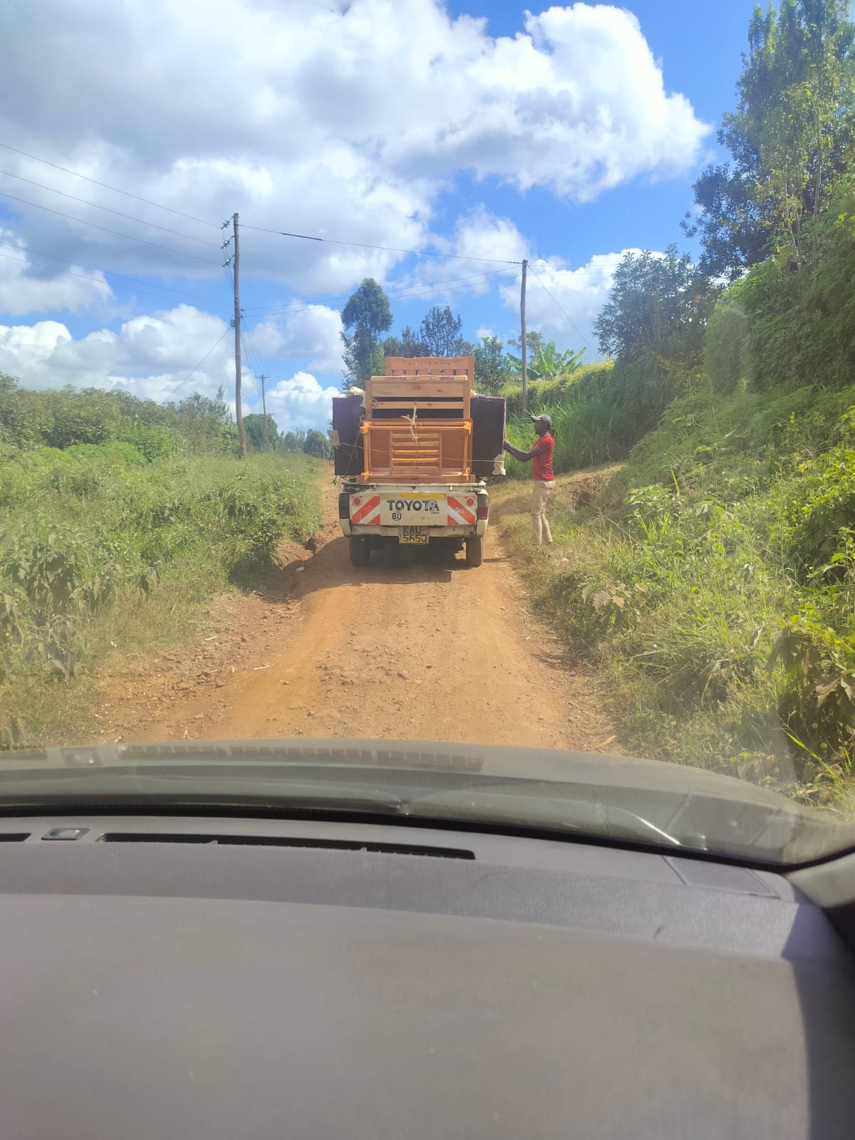 Here is a picture of the men bringing the furniture up the narrow road to the house.
