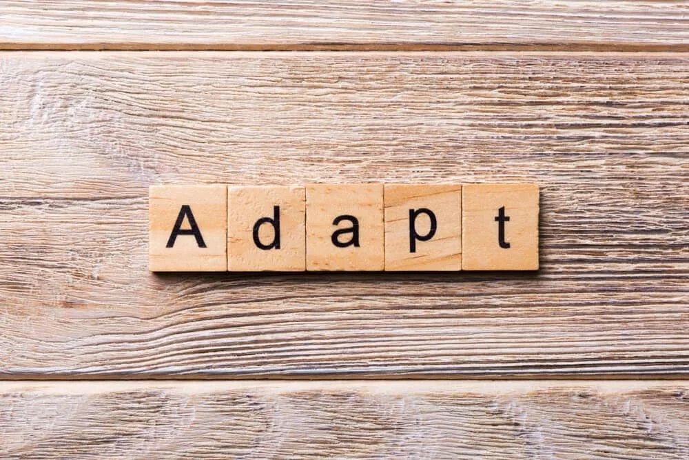 Scrabble tiles spelling out Adapt