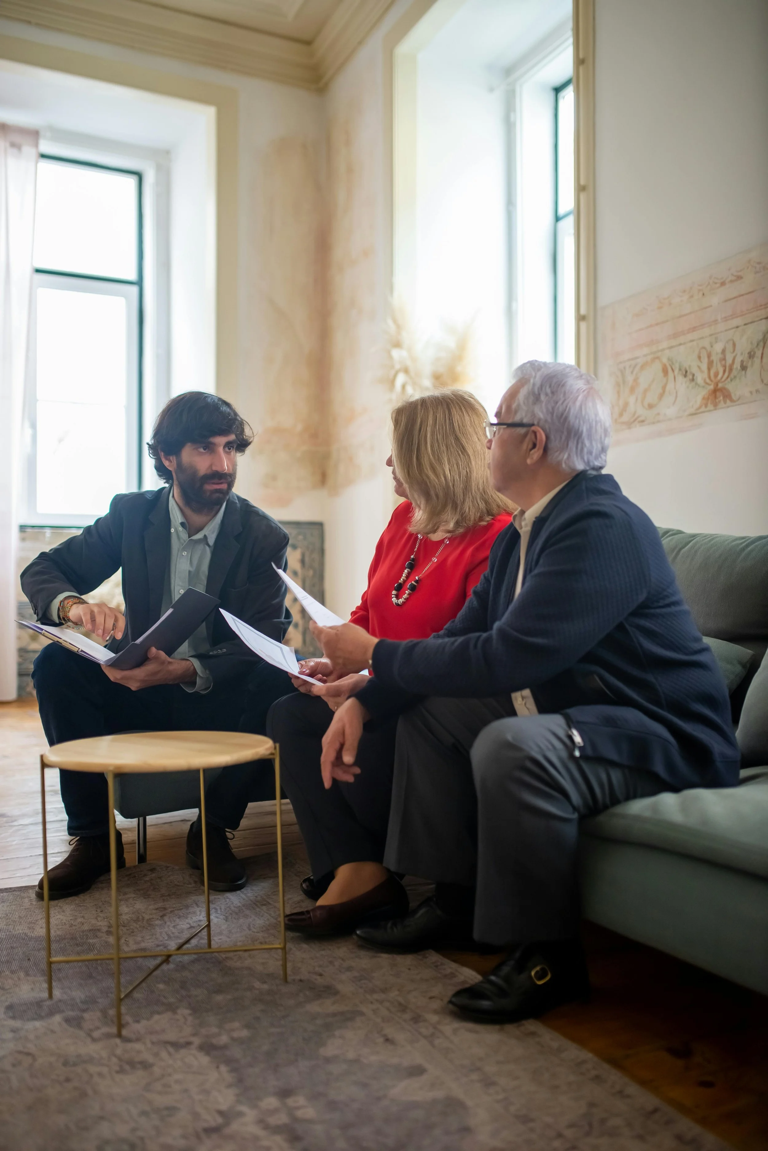 A stock photo of an advisor sitting with an family.