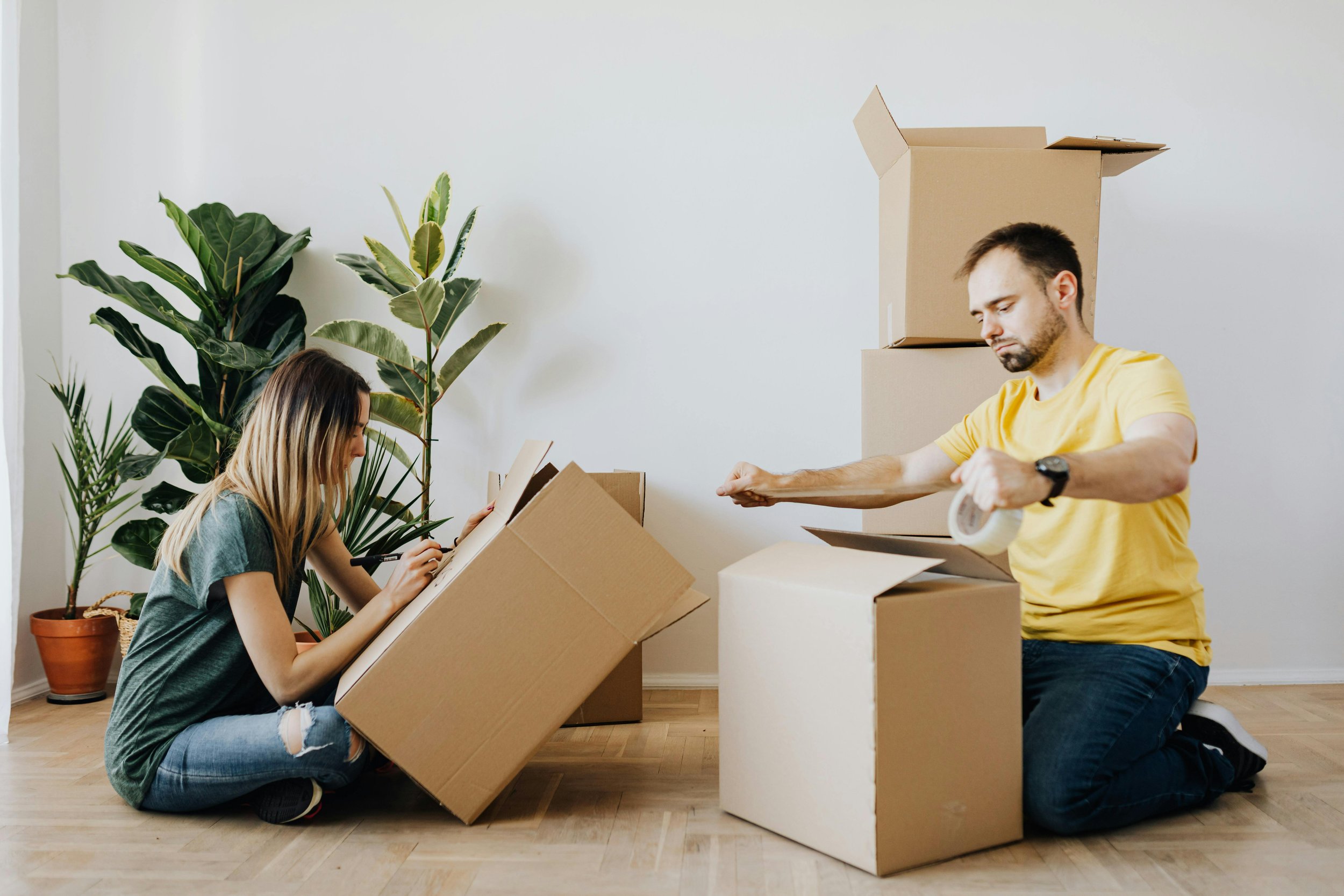 A man and a women packing boxes.