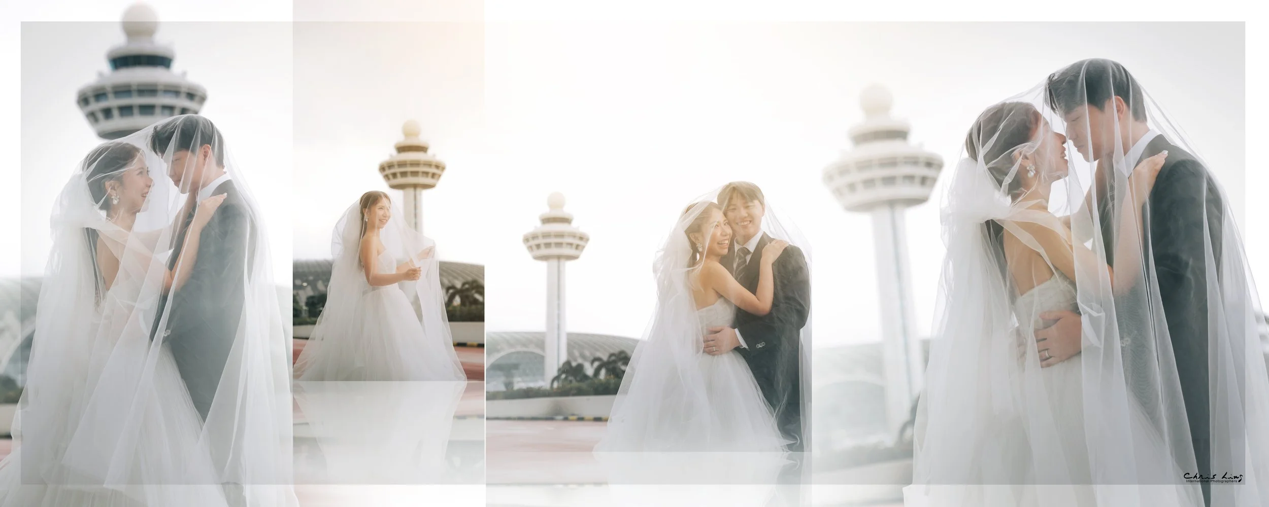 Couple dressed in wedding attire under a veil, embracing each other with a control tower in the background.