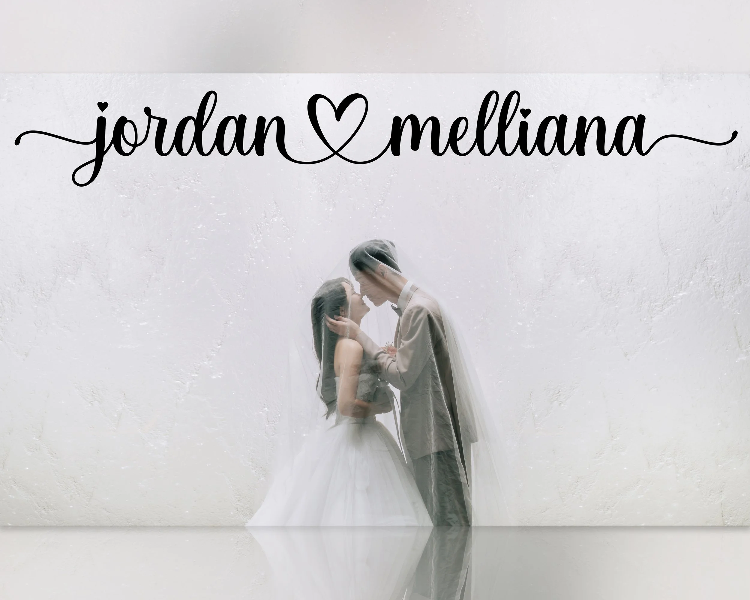 A bride and groom sharing a romantic moment behind a veil, with the names "Jordan" and "Melliana" written in a decorative black script at the top, connected by a heart shape.