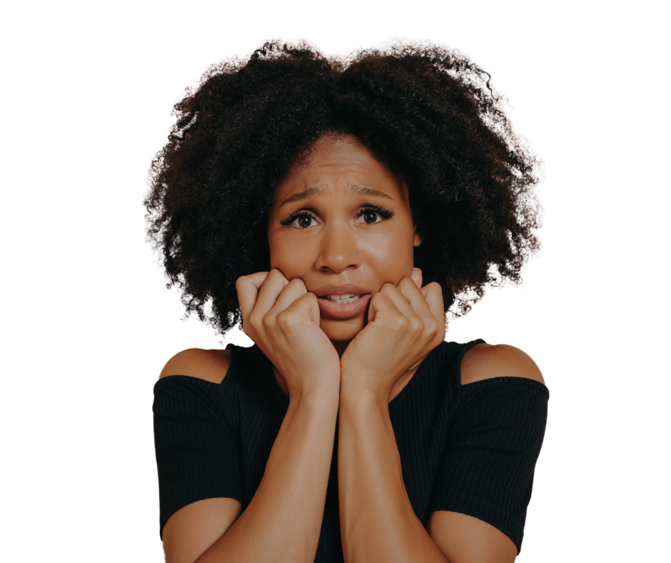 A worried woman with curly hair holds her face with both hands, looking anxious.