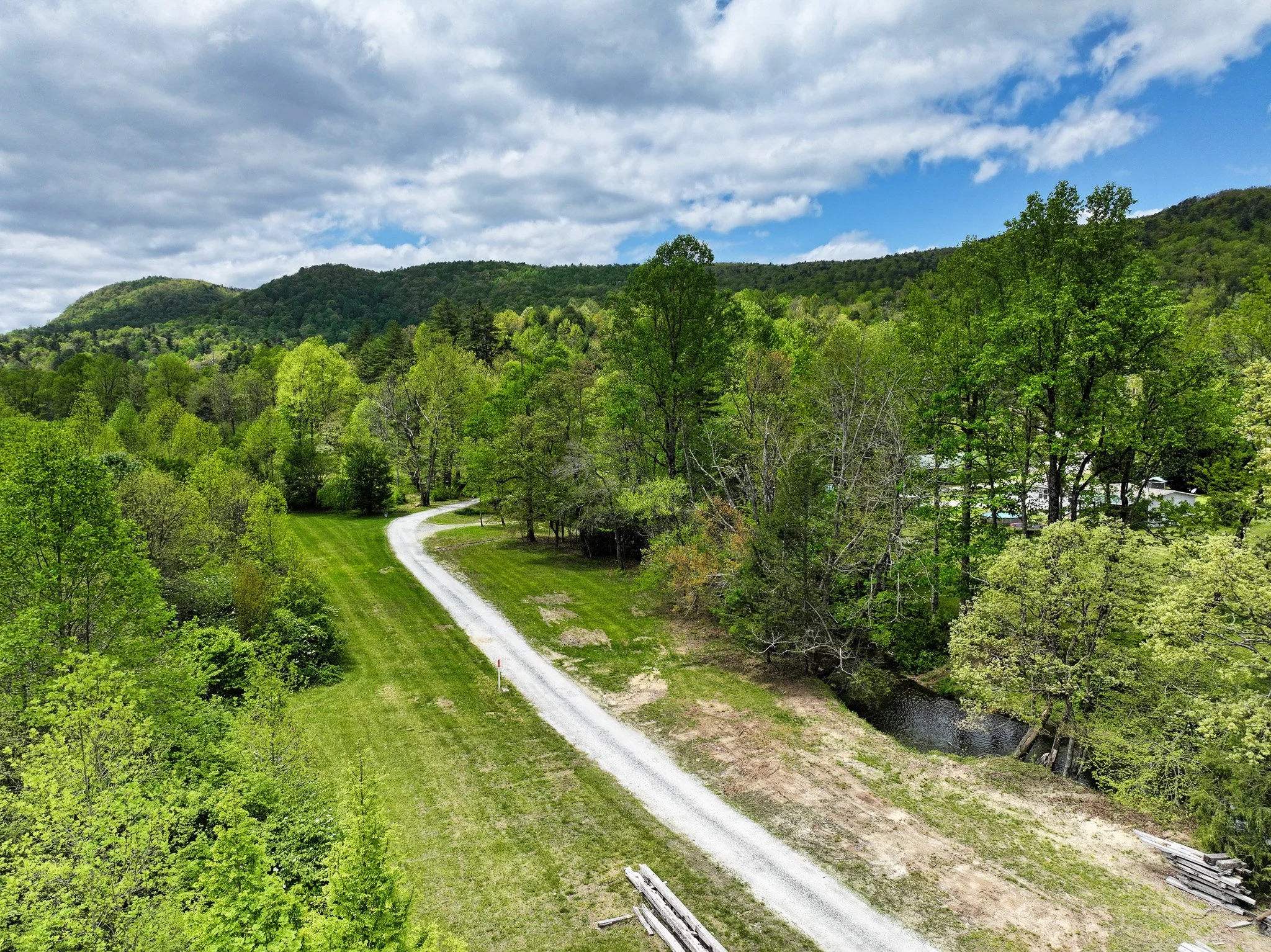 Blueberry farm road looking west from the outbuildings location, showing 6+ acres along the south side of the road.