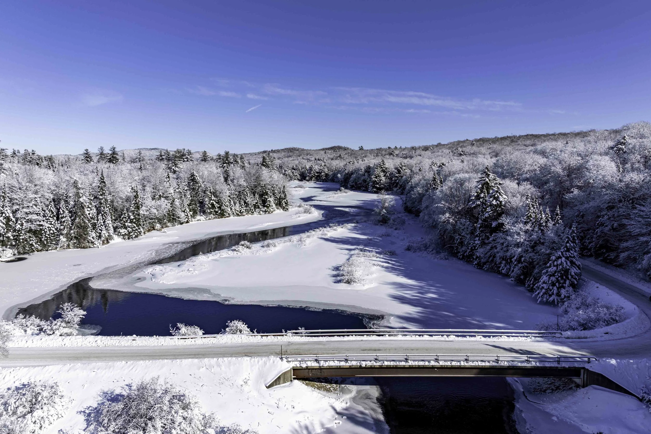 Aerial view of green bridge in Thendara, New York over The Moose River from Drone by Keen's Adirondack Photography