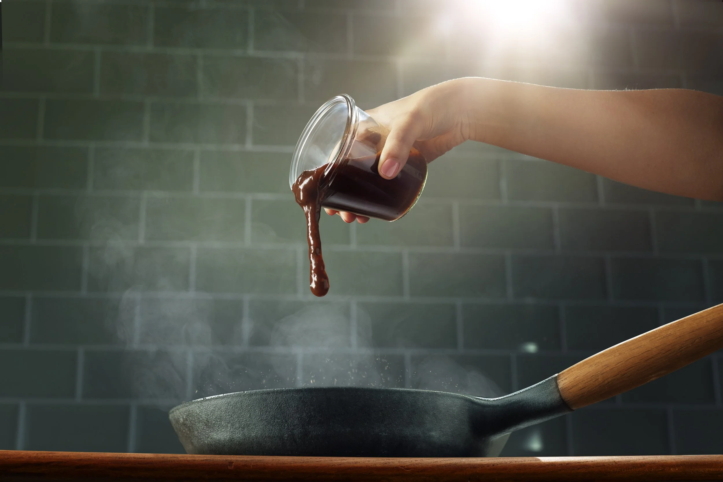 Jerk paste into frying pan- female hand copy.jpg