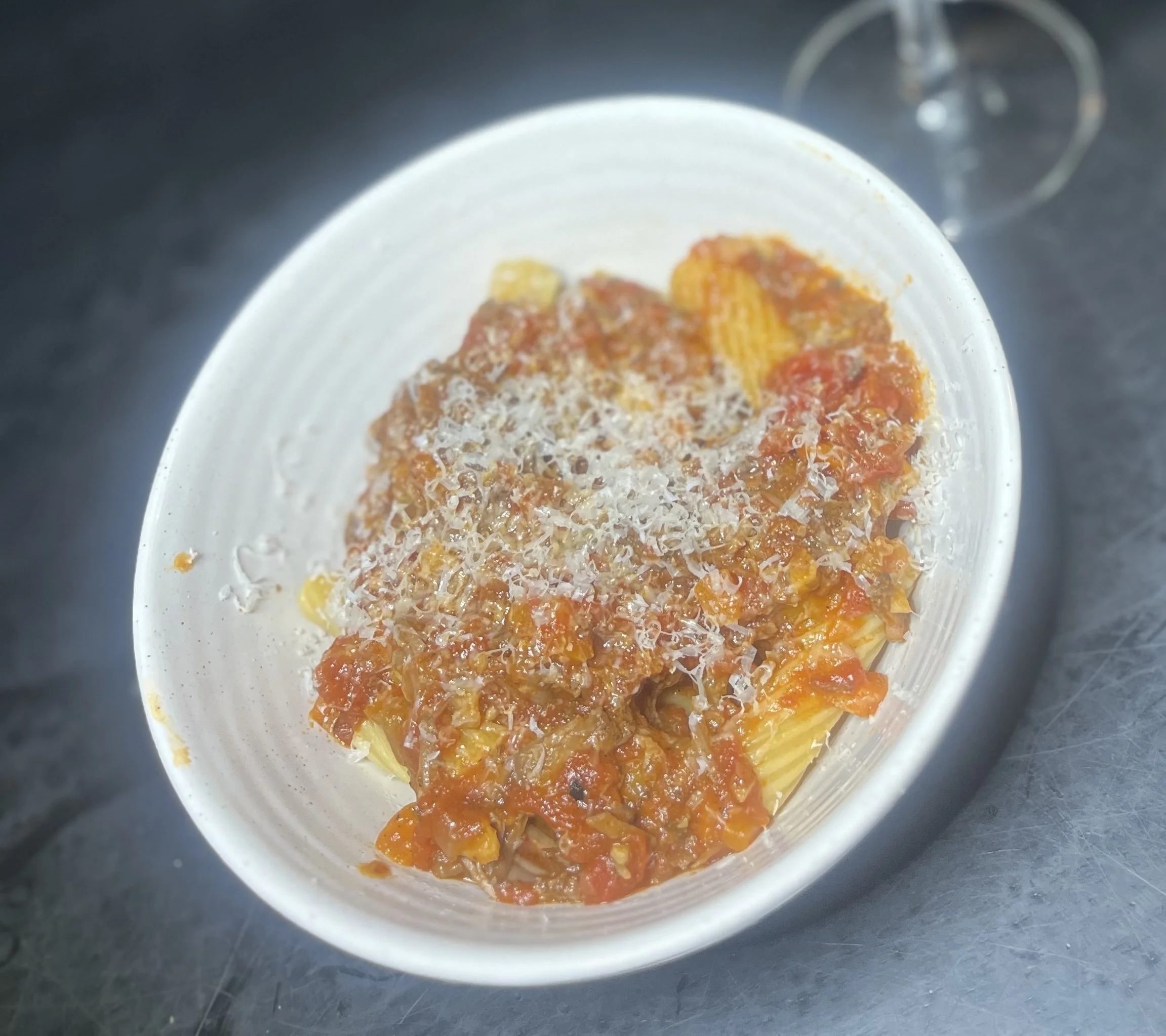 Close up rigatoni with leftover ragu and Mendocino Ridge Pinot Noir for recipes and pairing section 