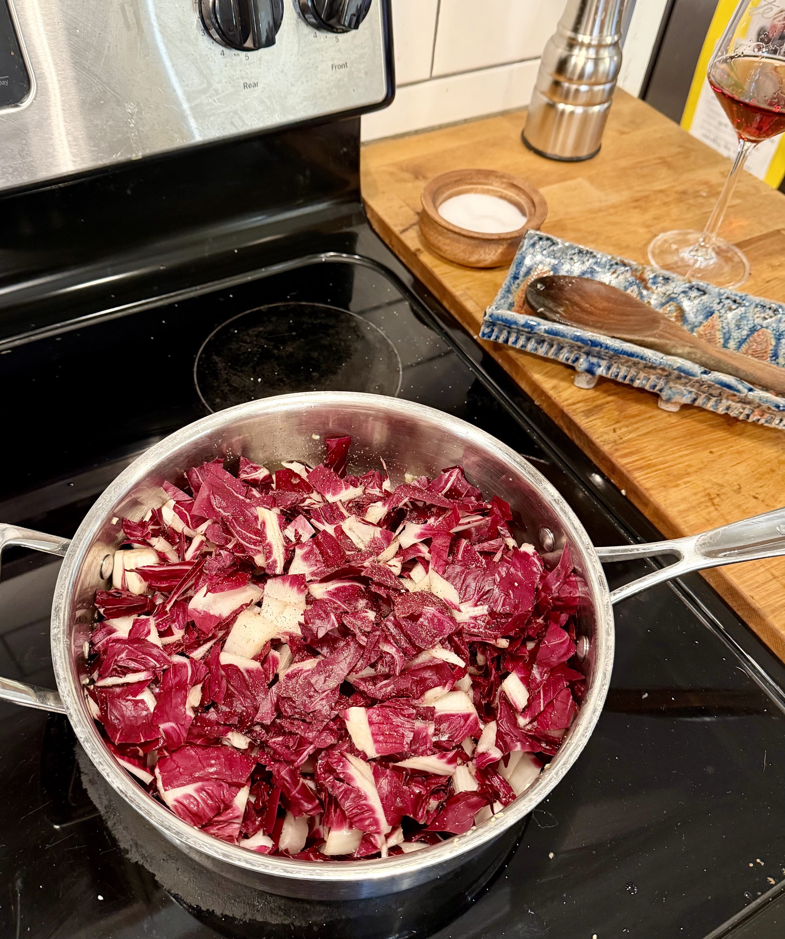 Colorful radicchio is added to the pan of aromatics for recipes and wine pairing Nebbiolo and Radicchio Risotto