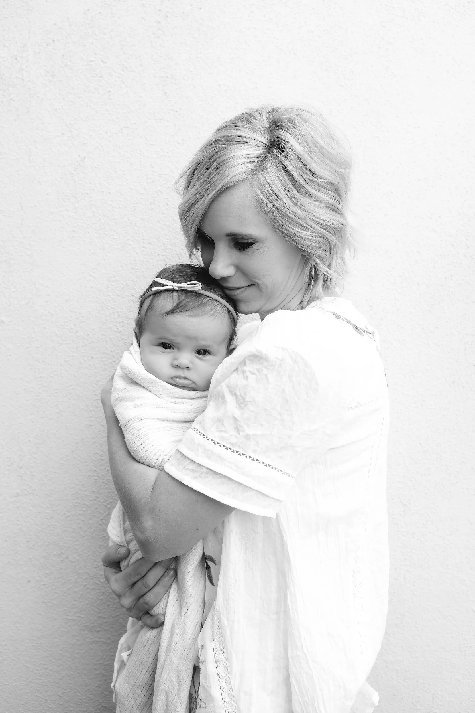 Newborn baby and postpartum mother.