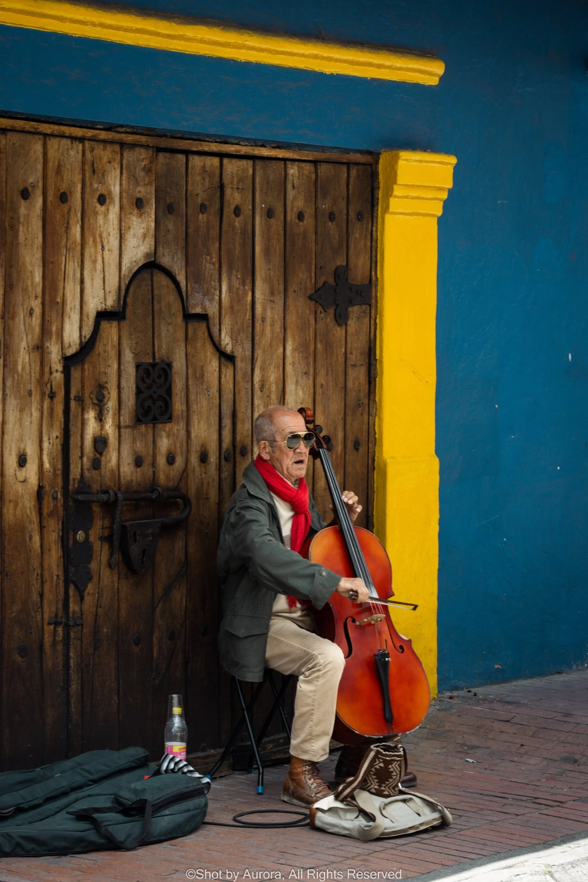 street-cellist-old-man-colorful-door-by-aurora.jpg