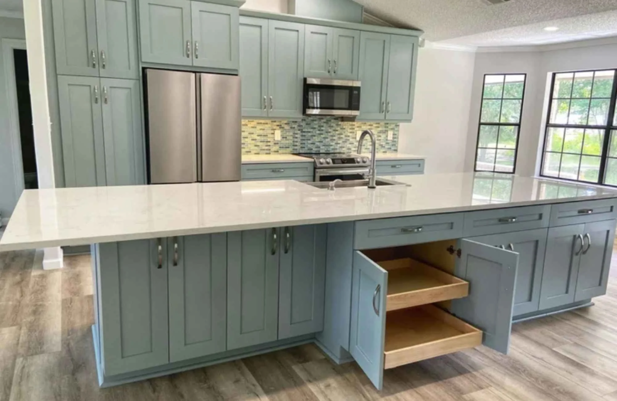ckd-remodeling-gulf-breeze-fl-kitchen-renovation-transformation-green-cabinets-with-pull-out-drawers-for-storage-large-island-collaborative-design.jpg