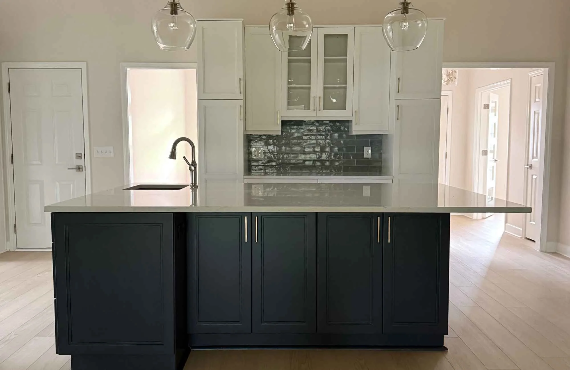 ckd-remodeling-pace-fl-full-gut-renovation-transformation-kitchen-with-dark-island-light-upper-cabinets-large-island-with-sink-precise-design.jpg