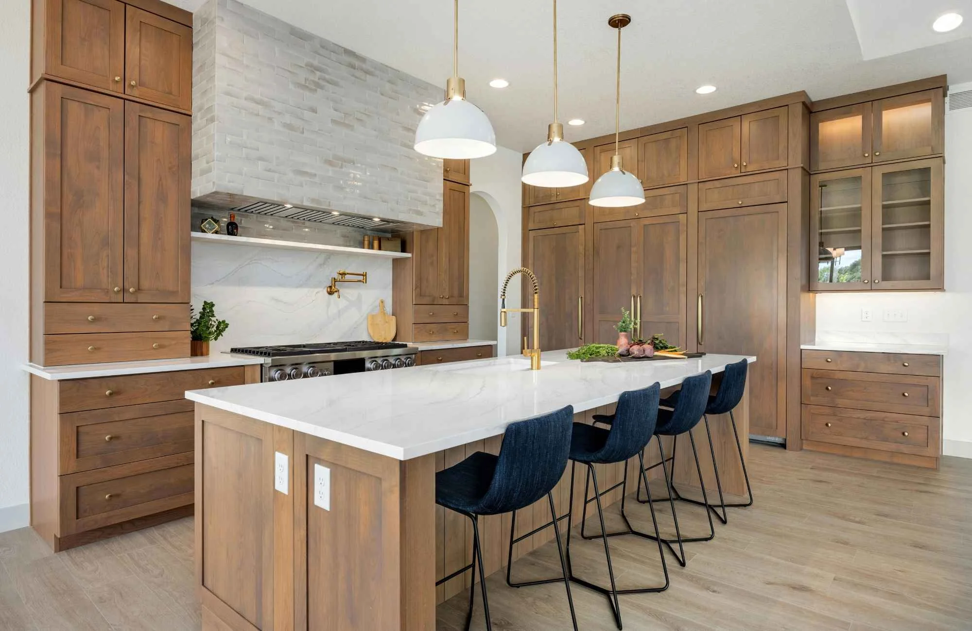 ckd-remodeling-milton-fl-backsplash-materials-luxury-kitchen-with-stained-wood-cabinets-slab-backsplash-large-island-white-countertops-quality-design-build.jpg