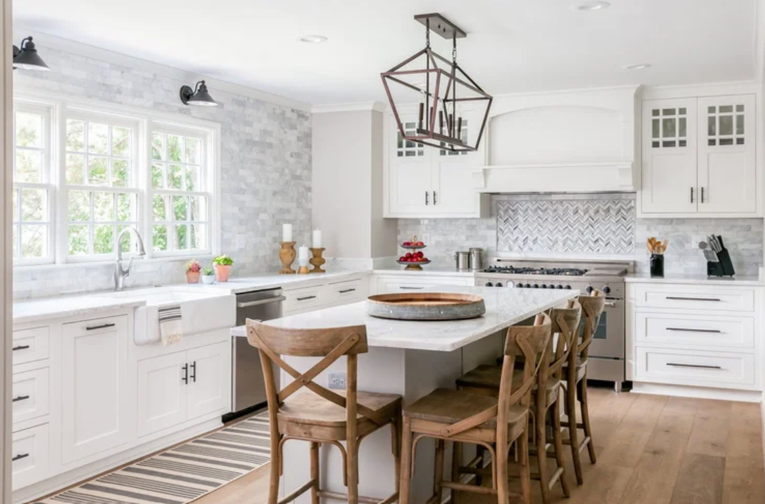 ckd-remodeling-gulf-breeze-fl-backsplash-material-farmhouse-kitchen-white-cabinets-and-countertop-x-back-bar-stools-large-window-collaborative.png