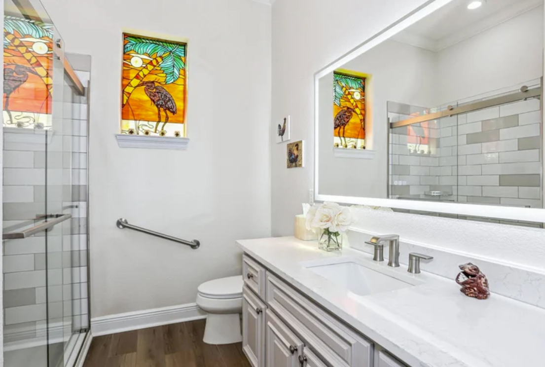 design-build-navarre-fl-bathroom-renovation-tips-neutral-colors-large-mirror-custom-stained-glass-window-collaborative-kitchen-renovation.png