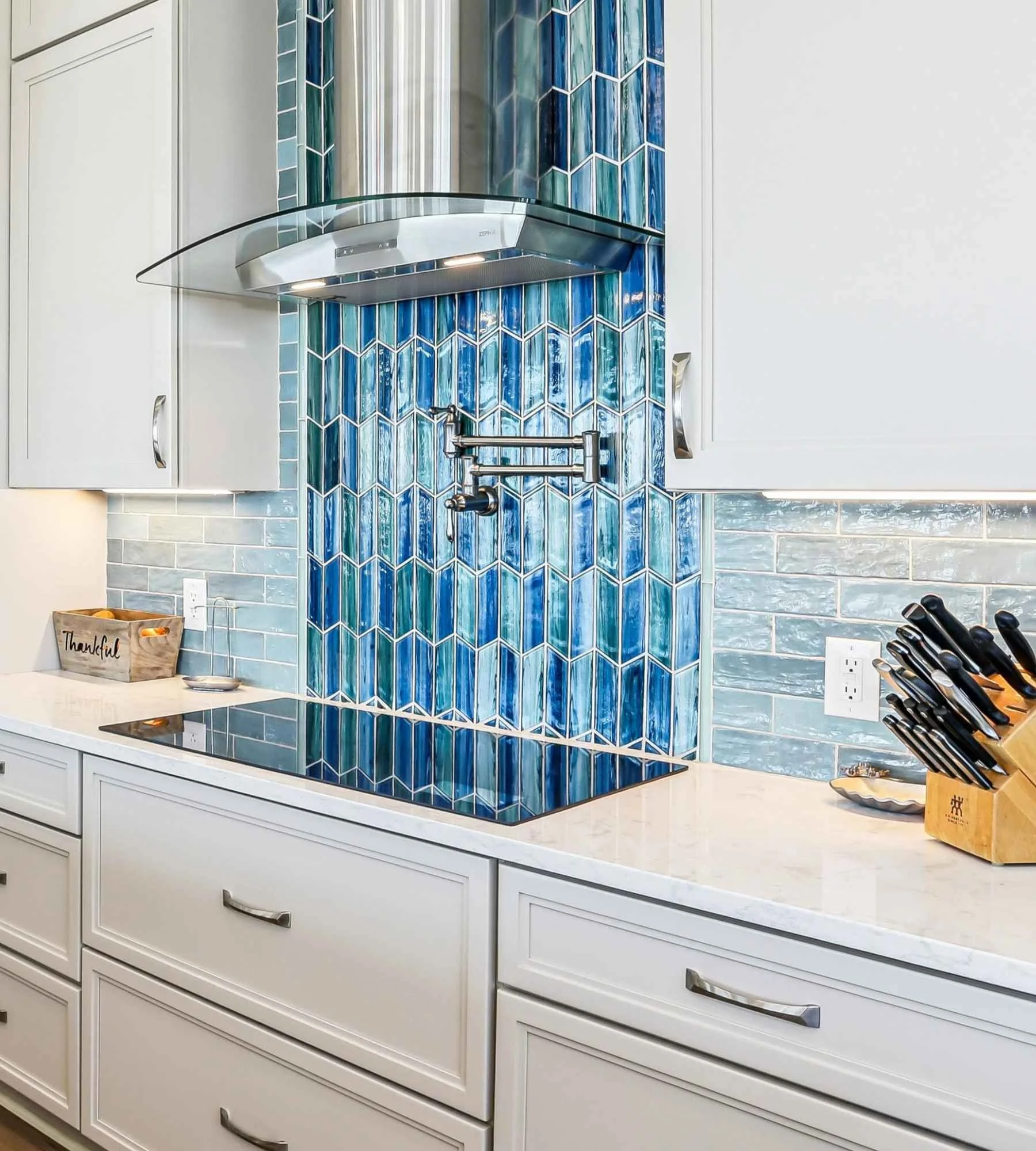 ckd-remodeling-milton-fl-colorful-kitchen-cabinets-and-backsplashes-white-cabinets-blue-vertical-backsplash-tile-behind-range-hood-pot-filler-quality.jpg