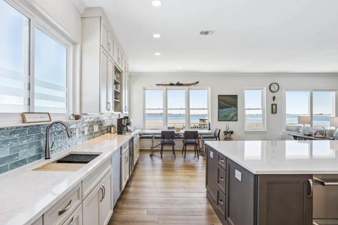 design-build-perdido-key-fl-lighting-impact-on-paint-colors-oceanfront-home-open-concept-kitchen-and-living-area-precise-bathroom-renovation.png