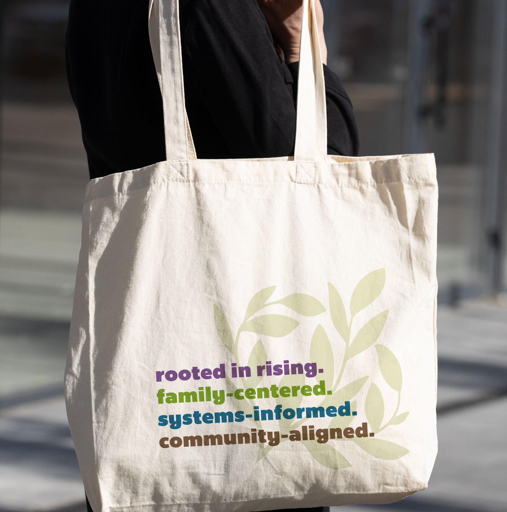 Family Systems Collective canvas tote bag with rooted in rising tagline