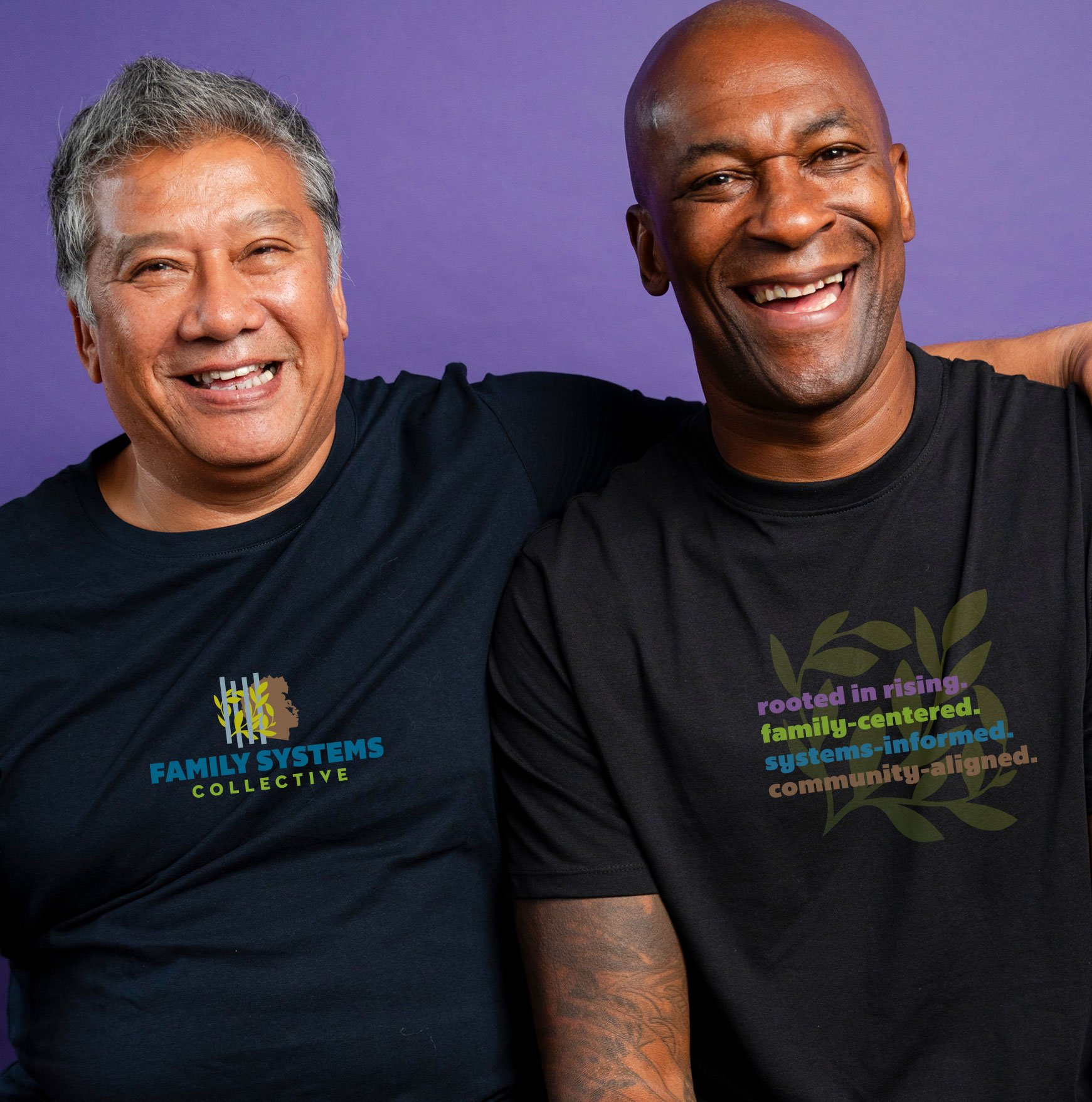two men wearing Family Systems Collective black tee shirts