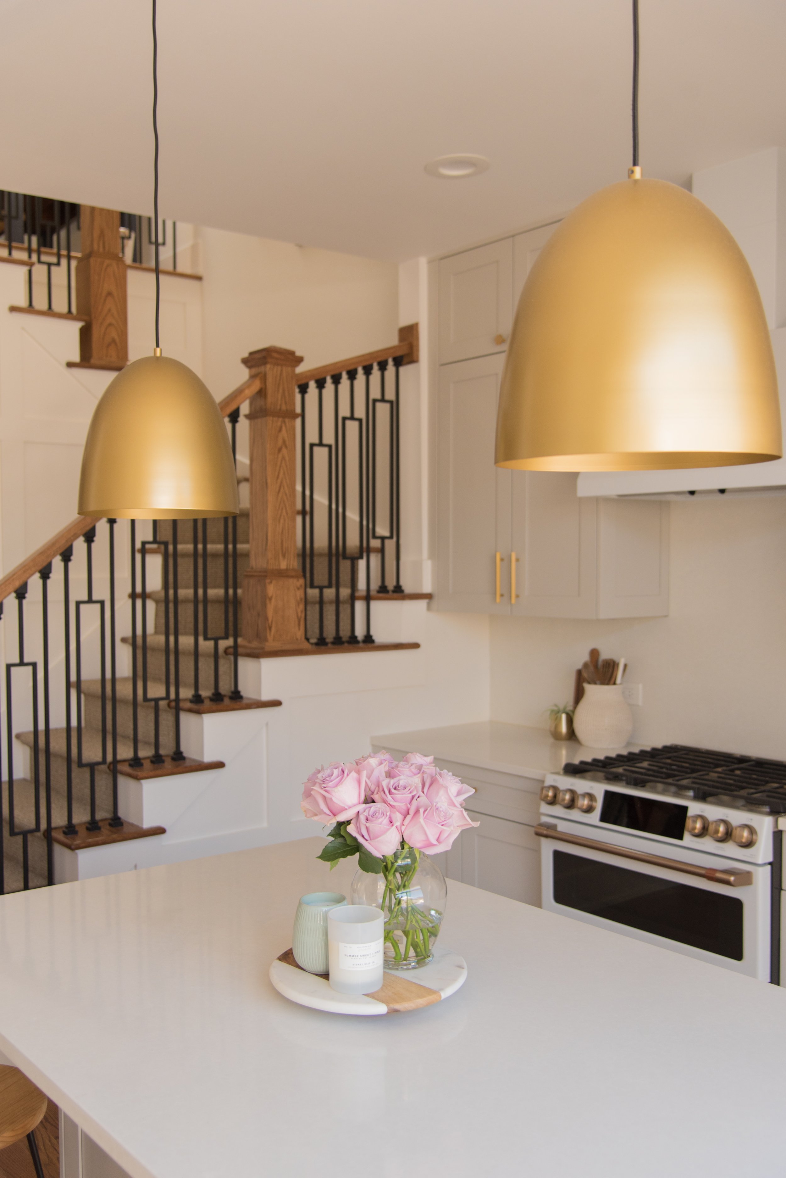 closer look on gold hanging lights on the kitchen island