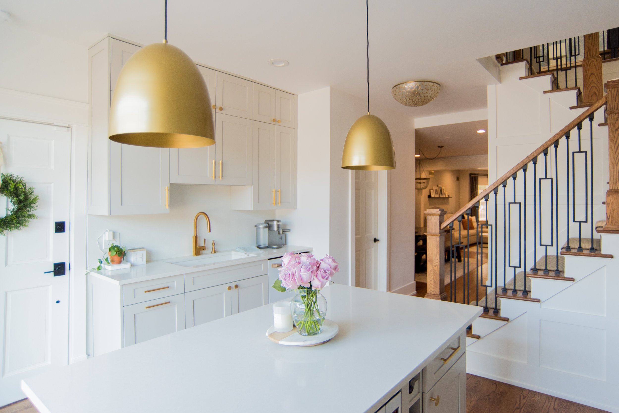 kitchen island with gold lamps and gold kitchen accents