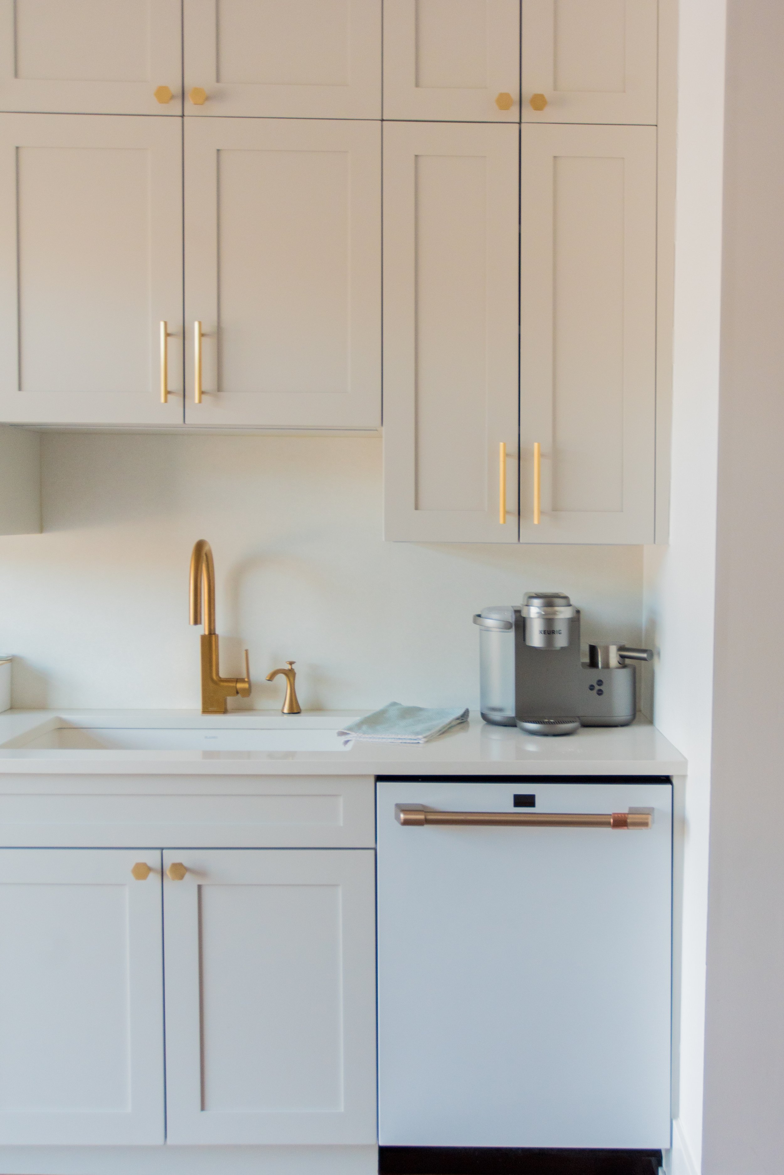 closer look of kitchen cabinets with gold accents