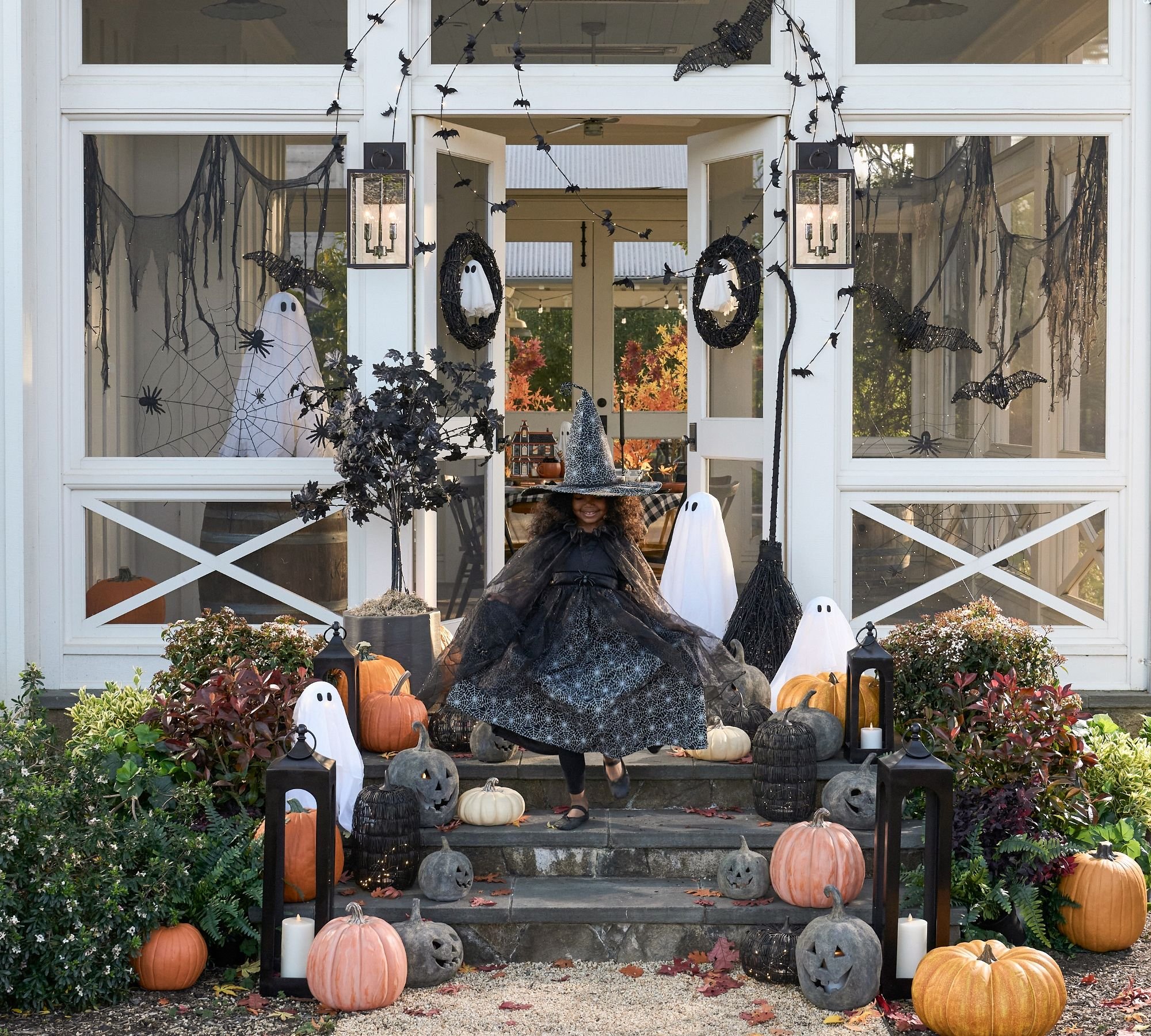 For a spooky porch, consider hanging fake cobwebs, jack-o-lanterns, and a festive welcome mat. Indoors, set up a haunted house scene with fake skeletons, bats, and witches' hats, along with orange string lights and a bowl of candy for trick-or-treaters. Add a fog machine or eerie music for extra ambiance.