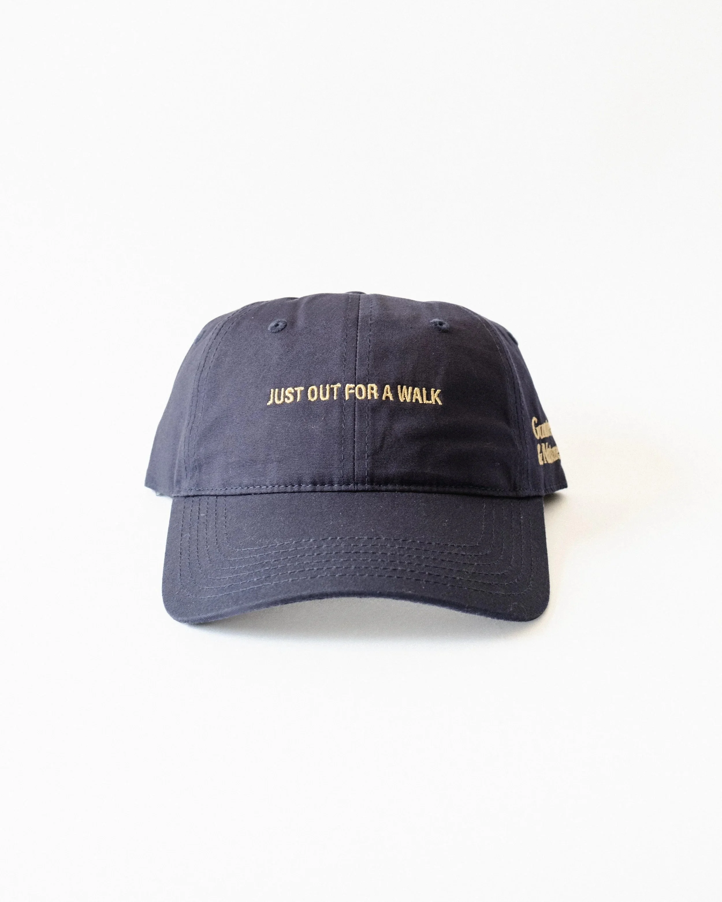 Navy and gold Just Out For A Walk dad hat, front view