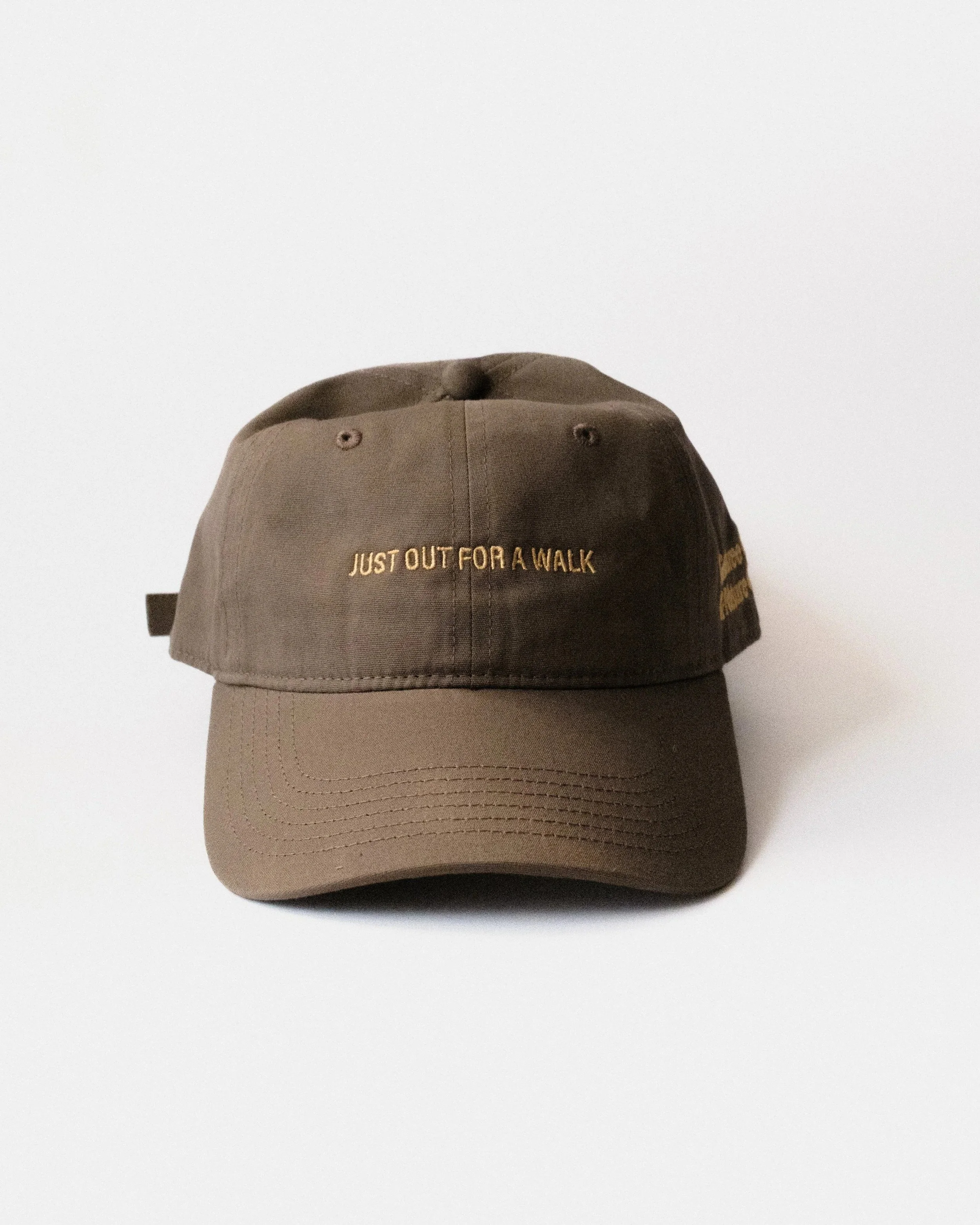 Brown and yellow Just Out For A Walk dad hat, front view